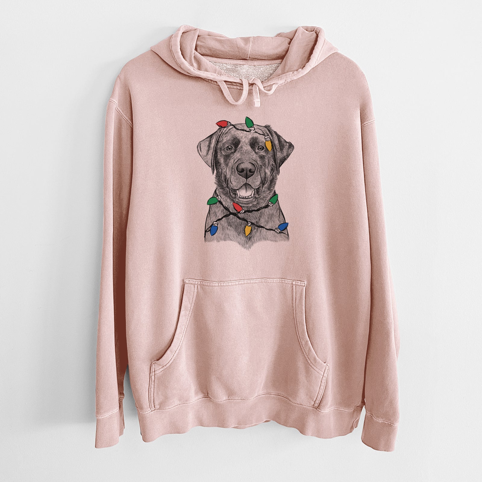 Hand-drawn sketch of Heath the Black Lab wrapped in Christmas lights on a Dusty Pink Unisex pigment dyed hoodie
