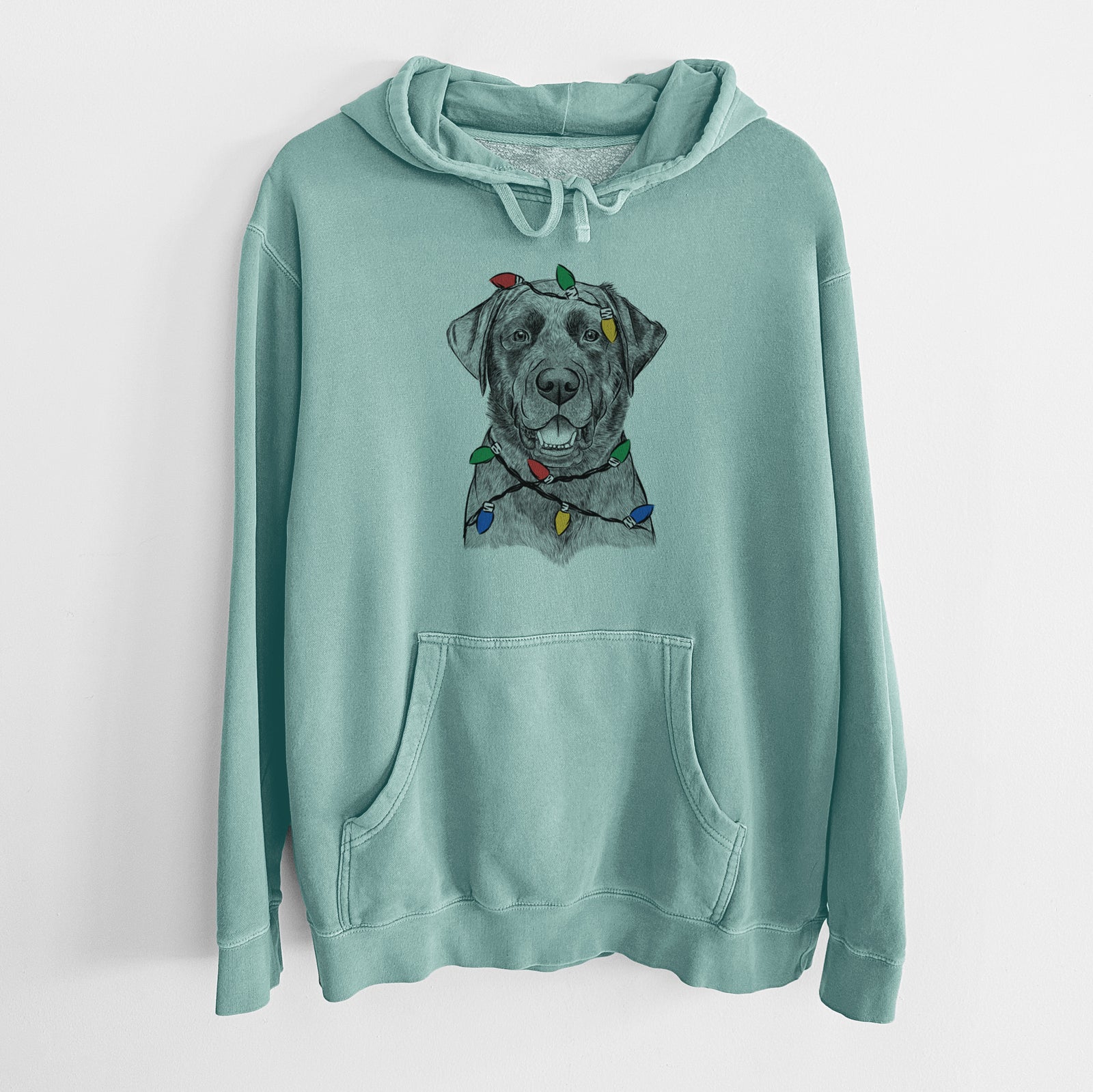 Hand-drawn sketch of Heath the Black Lab wrapped in Christmas lights on a Mint Unisex pigment dyed hoodie