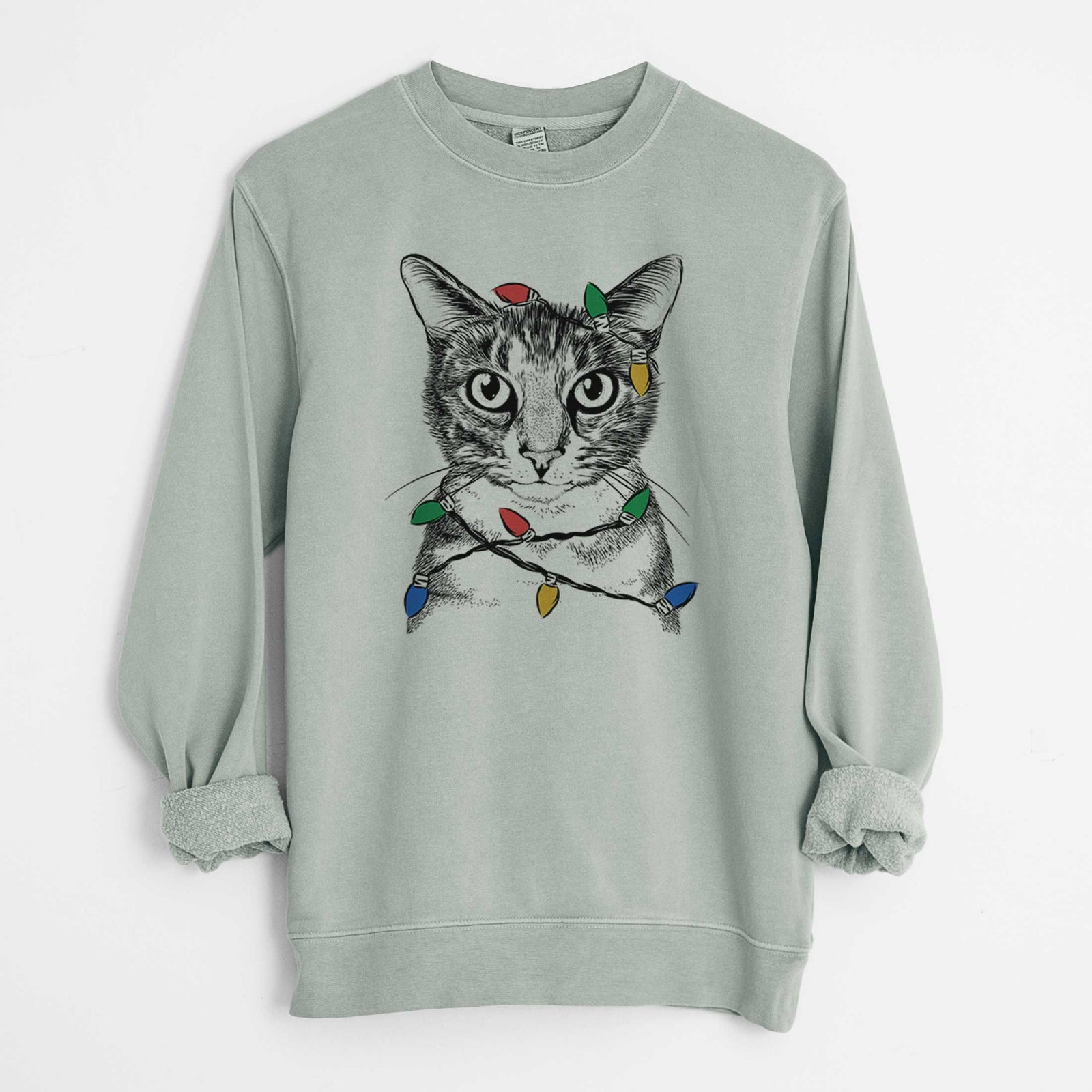 Hand-drawn sketch of Hobbes the Tabby Cat wrapped in Christmas lights on a Sage Unisex pigment dyed crew sweatshirt