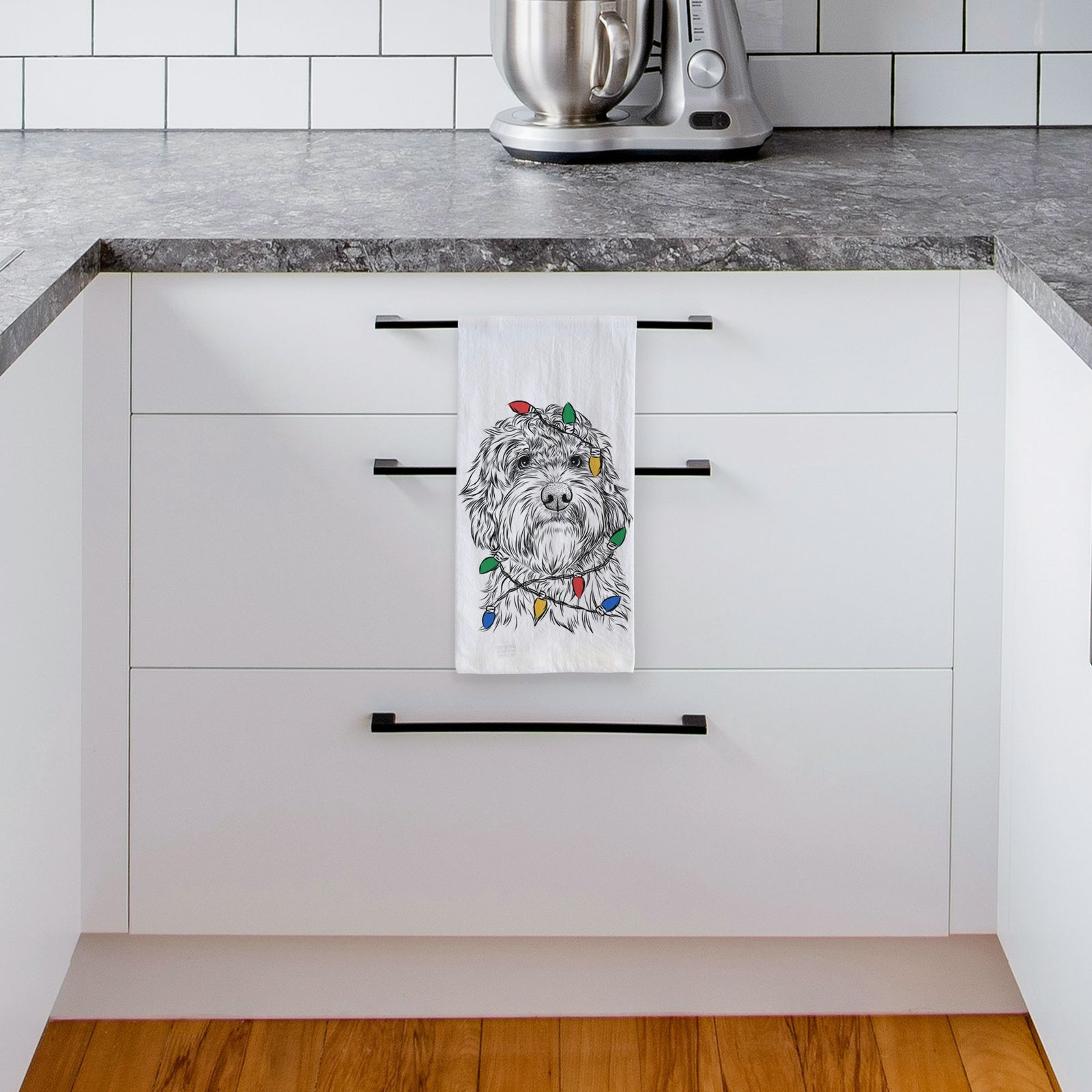 Hand-drawn sketch of Huckleberry the Australian Labradoodle wrapped in Christmas lights on a tea towel, hanging on an oven door in a kitchen