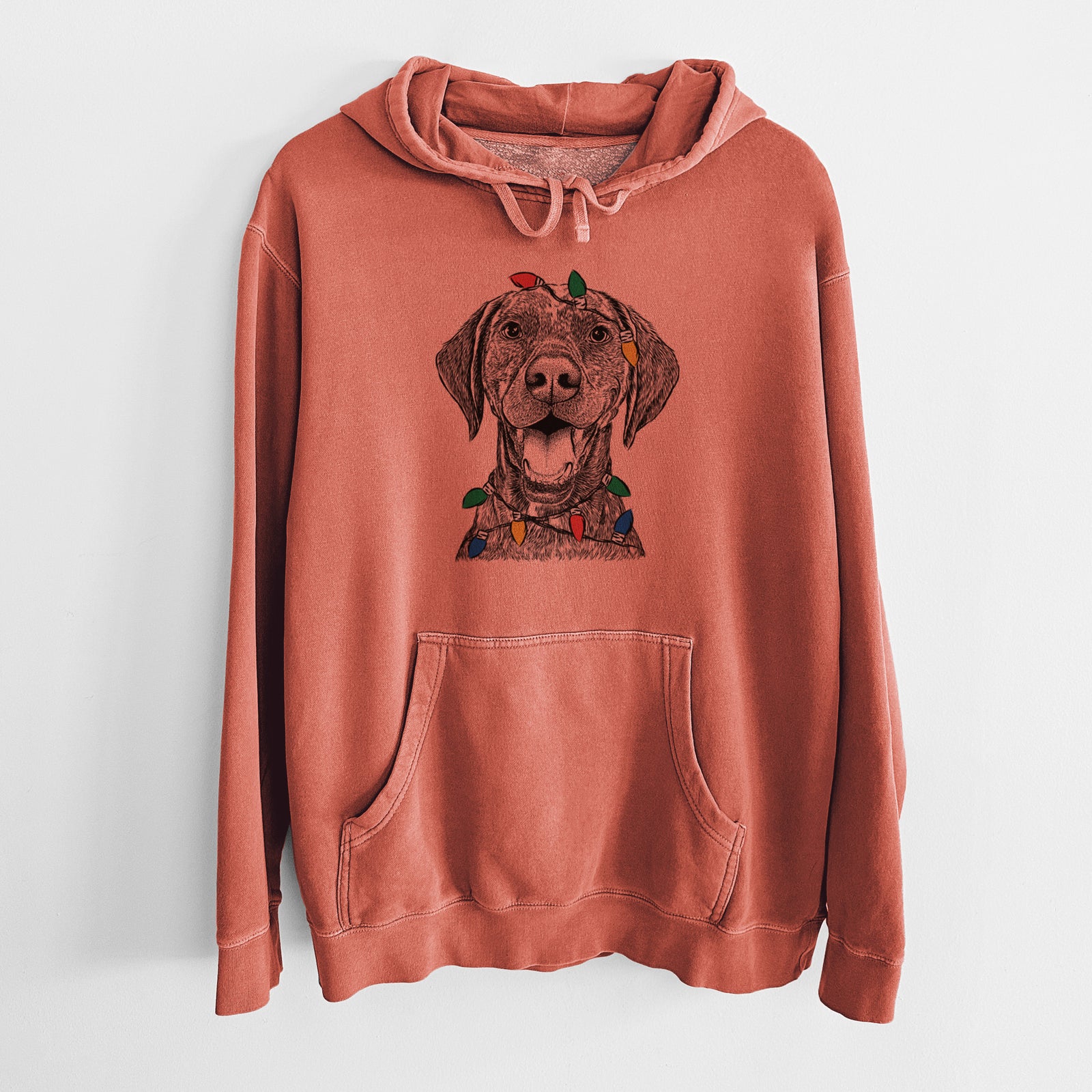 Hand-drawn sketch of Hudson the German Shorthaired Pointer wrapped in Christmas lights on an Amber Unisex pigment dyed hoodie
