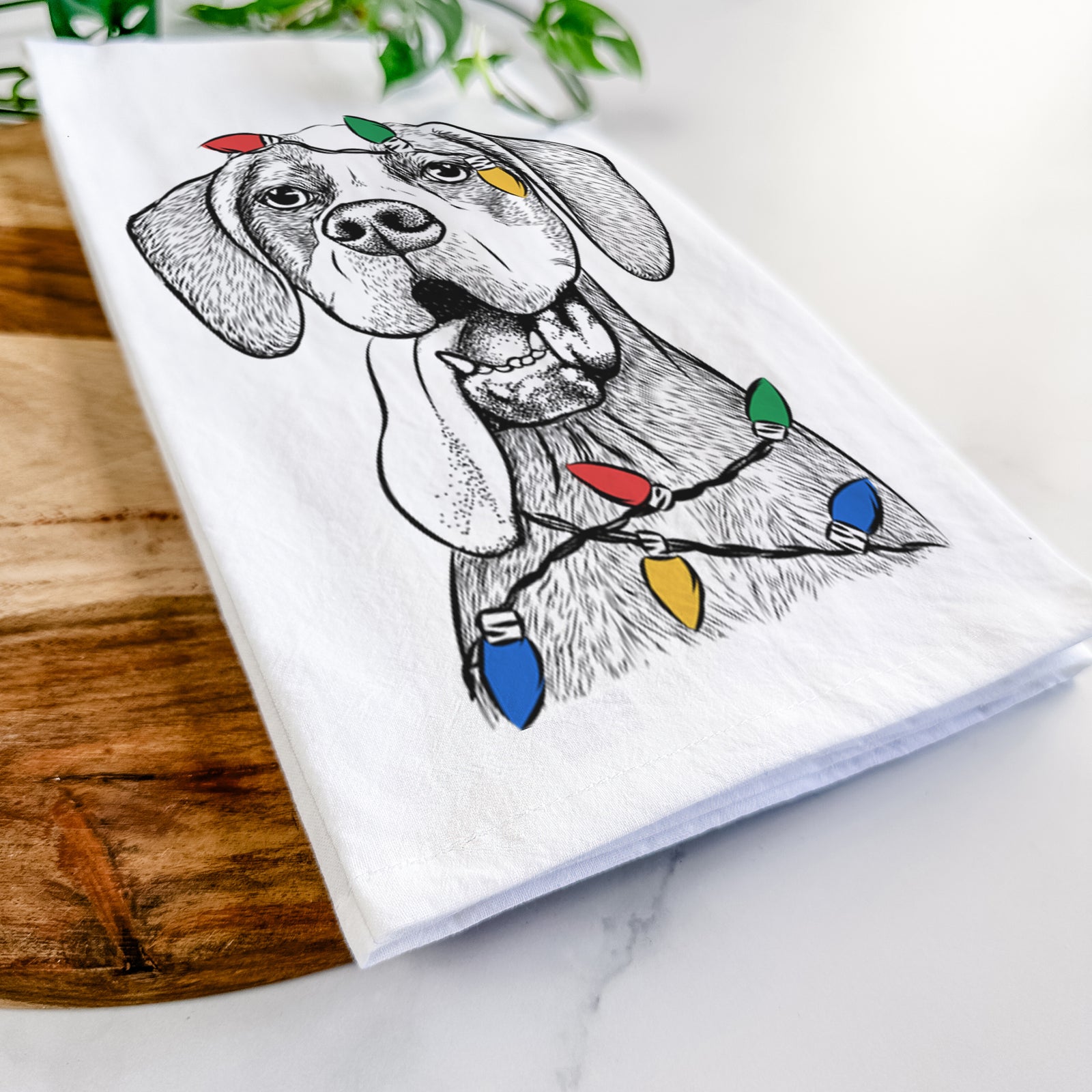 Hand-drawn sketch of Irwin the English Pointer wrapped in Christmas lights on a tea towel