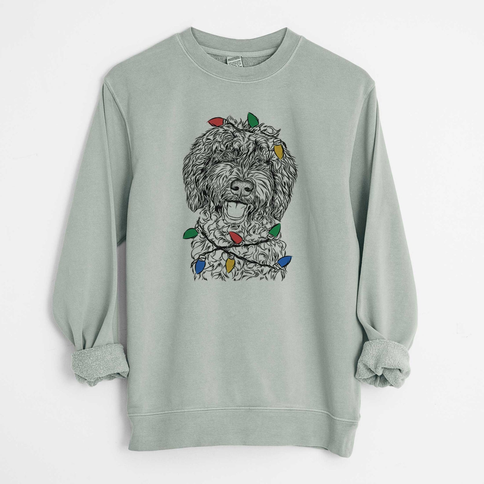Hand-drawn sketch of Jack the Chocolate Labradoodle wrapped in Christmas lights on a Sage Unisex pigment dyed crew sweatshirt
