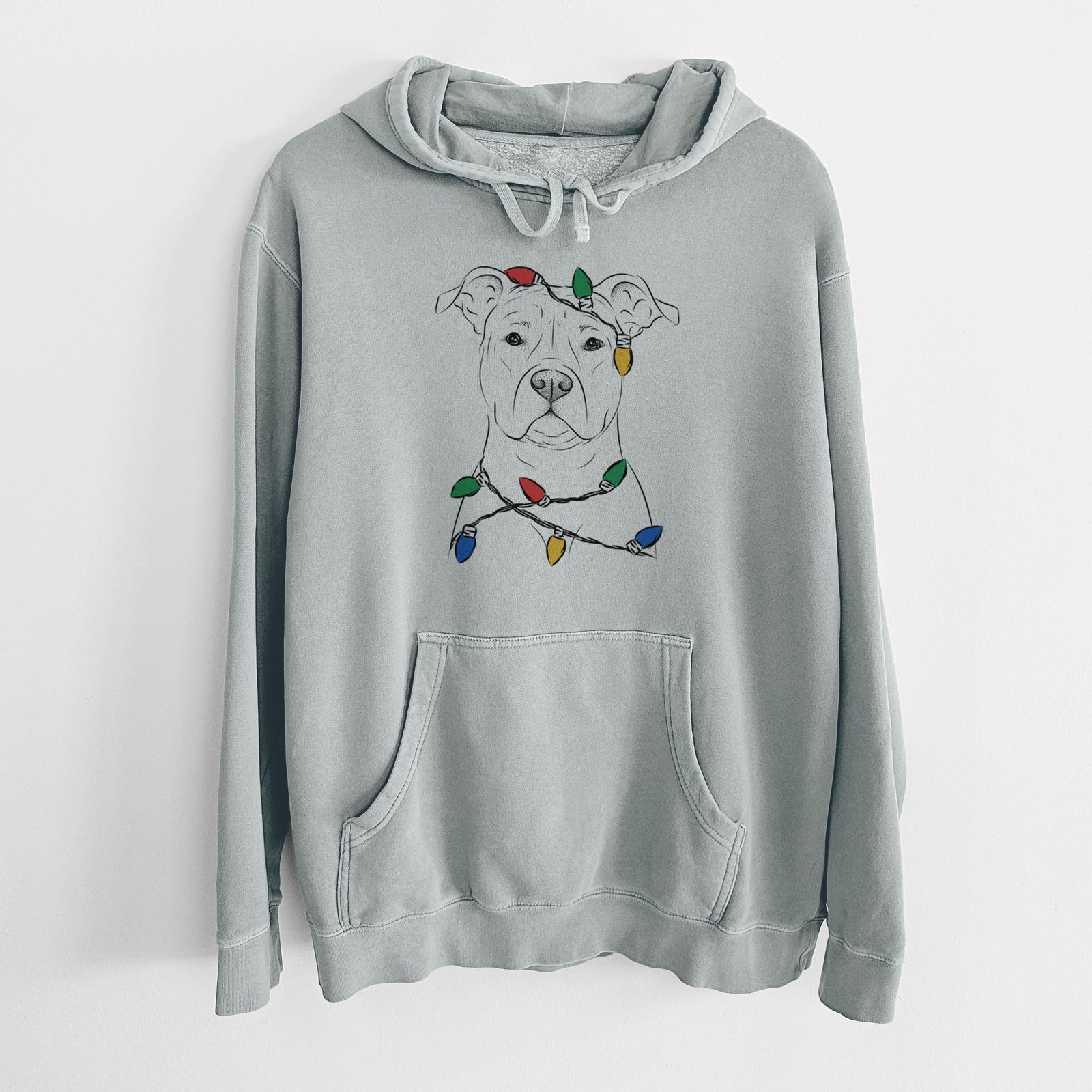 Hand-drawn sketch of Jethro the American Staffordshire Terrier wrapped in Christmas lights on a Sage Unisex pigment dyed hoodie