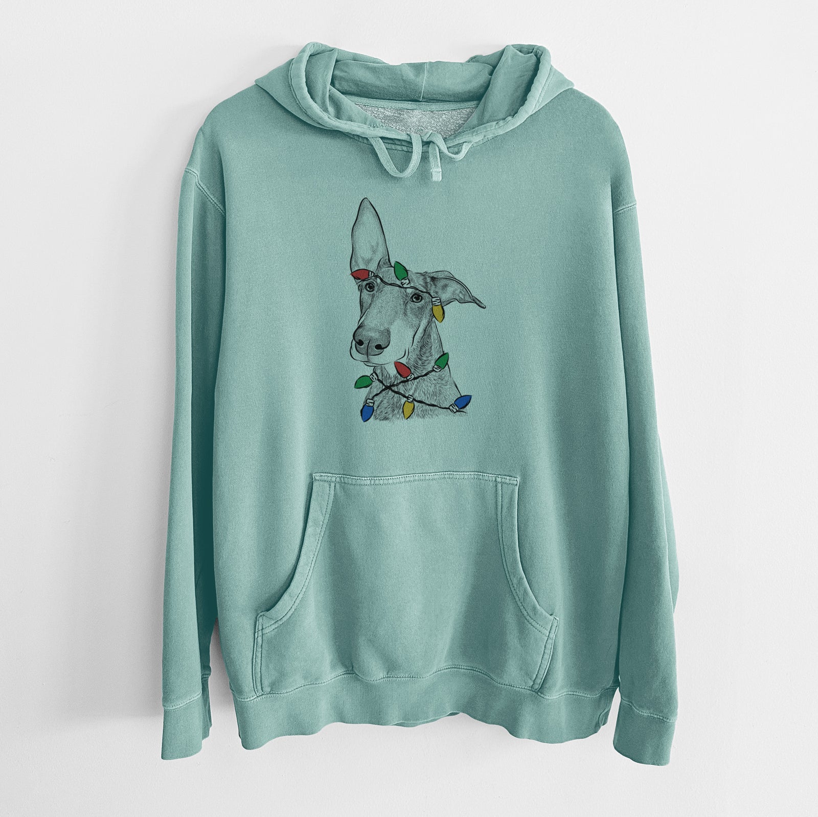 Hand-drawn sketch of Kain the Doberman Pinscher wrapped in Christmas lights on a Mint Unisex pigment dyed hoodie