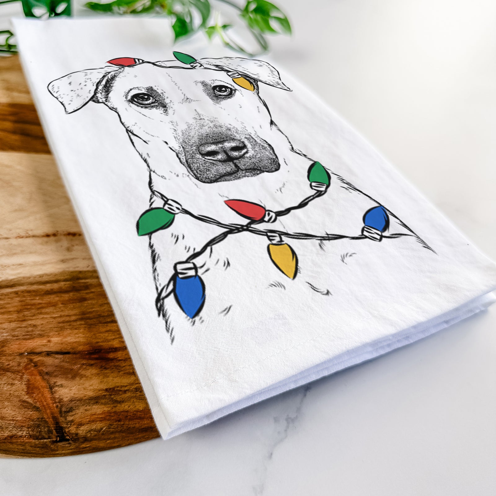 Hand-drawn sketch of Luna the Black Mouth Cur wrapped in Christmas lights on a tea towel