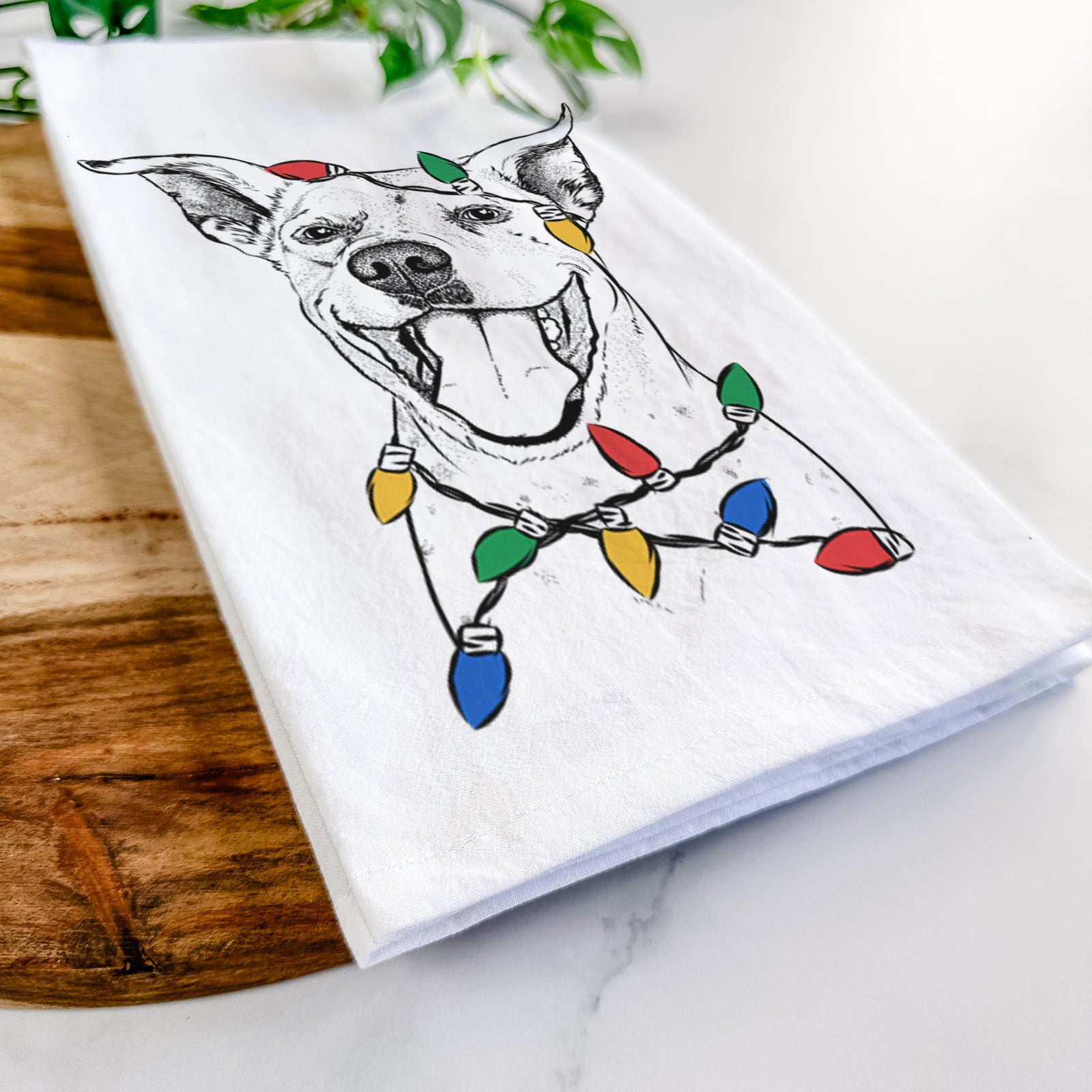 Hand-drawn sketch of Maddie the Dalmatian Pitbull Mix wrapped in Christmas lights on a tea towel