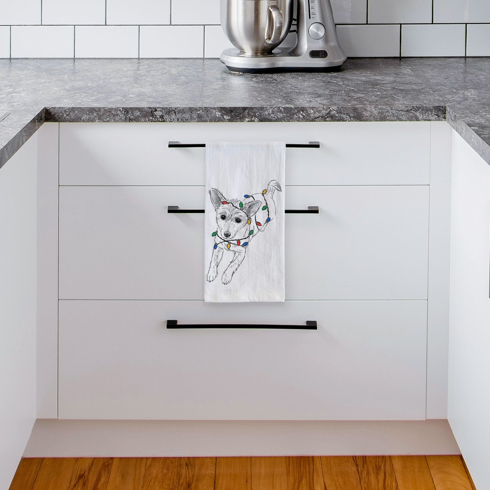 Hand-drawn sketch of Maisie the Terrier Mix wrapped in Christmas lights on a tea towel, hanging on an oven door in a kitchen