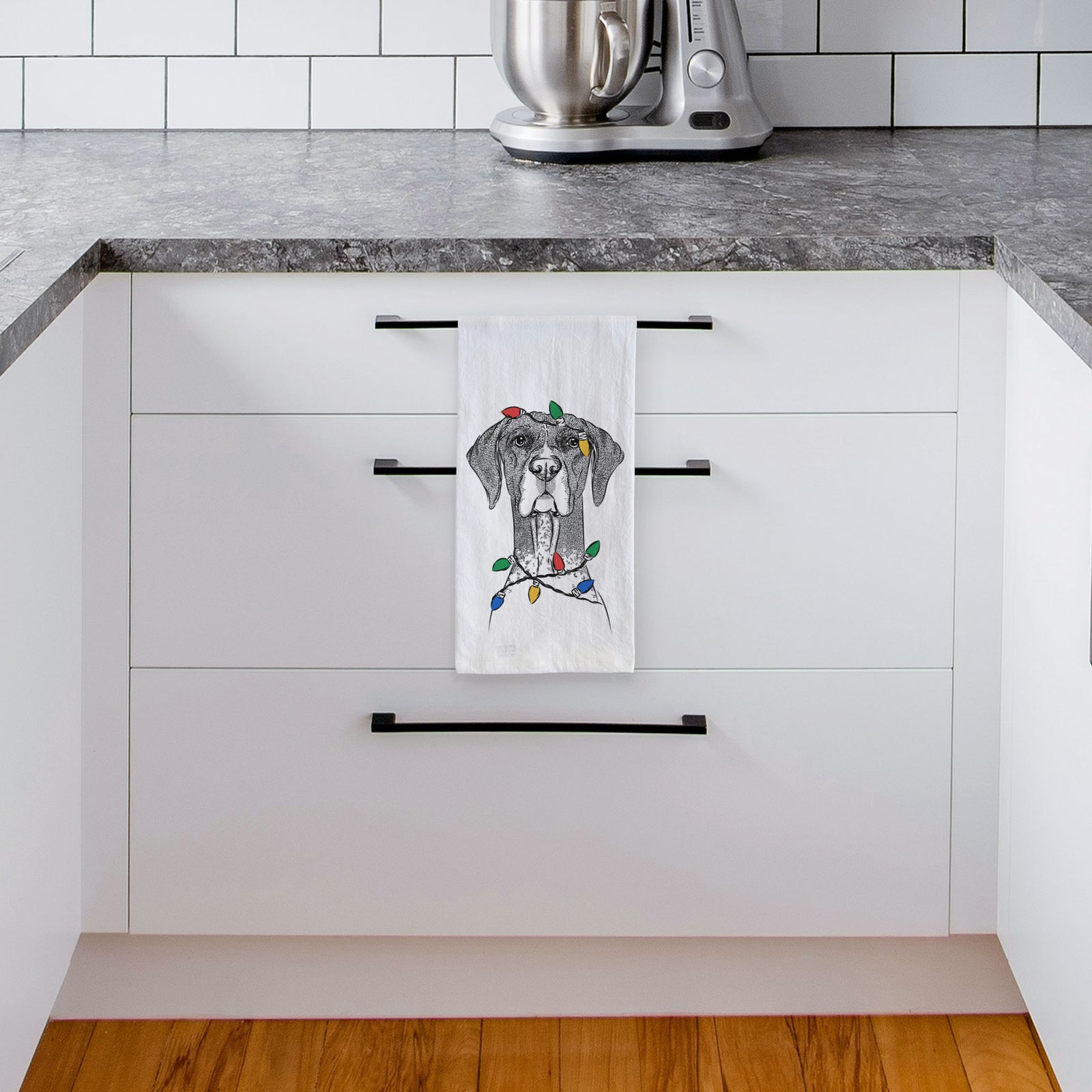 Hand-drawn sketch of Mattis the German Shorthaired Pointer wrapped in Christmas lights on a tea towel, hanging on an oven door in a kitchen