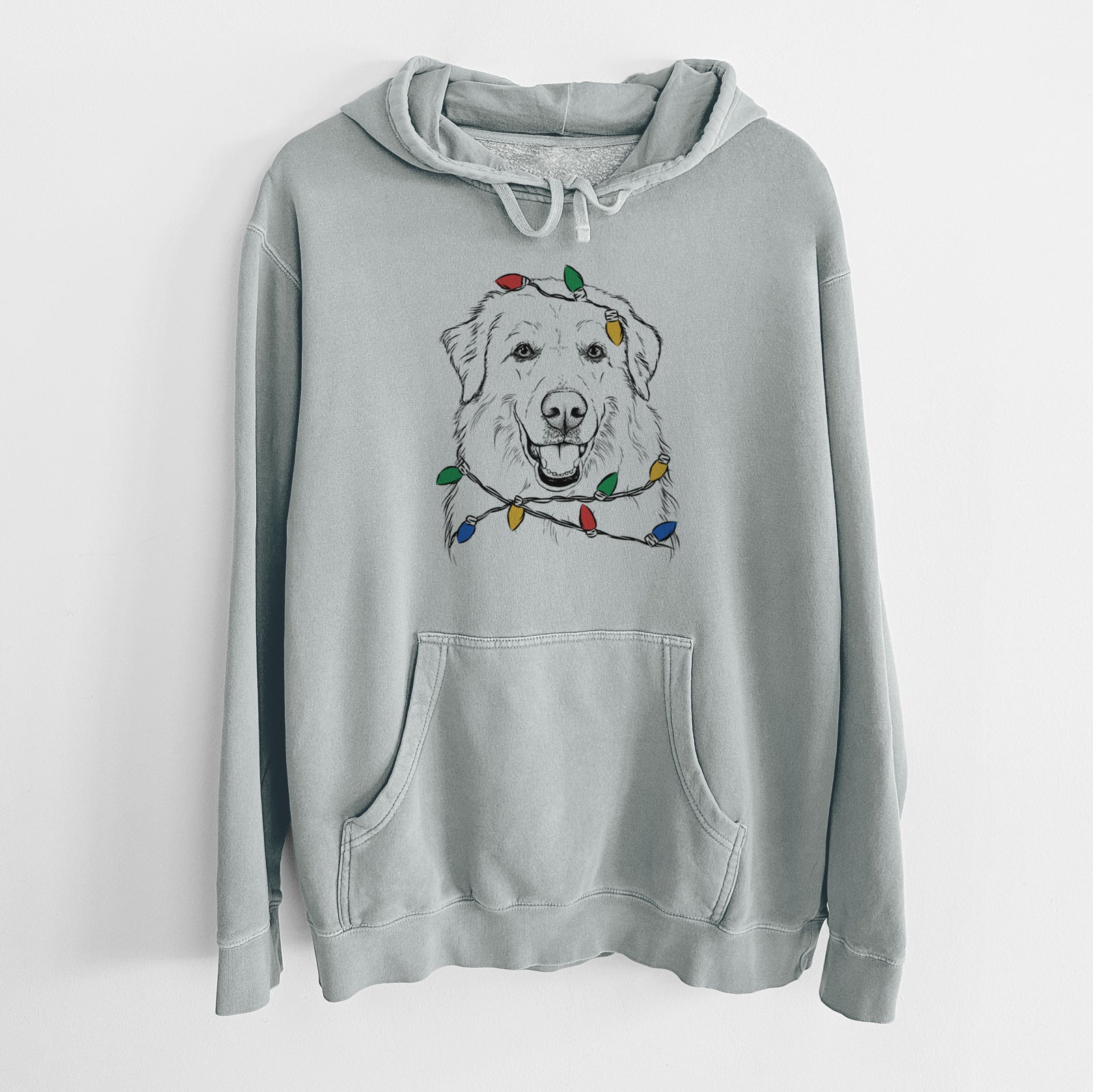 Hand-drawn sketch of Meg the Great Pyrenees wrapped in Christmas lights on a Sage Unisex pigment dyed hoodie