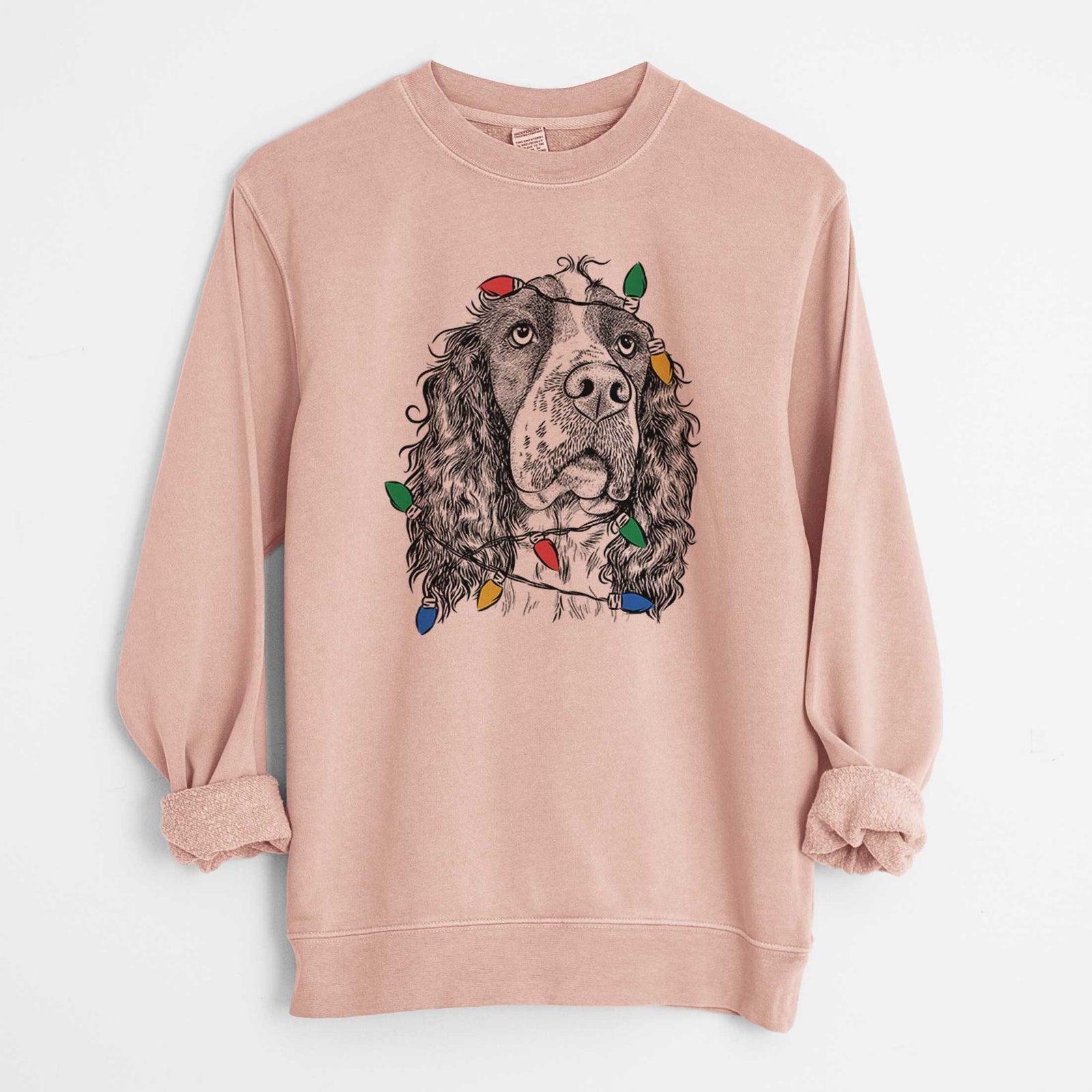 Hand-drawn sketch of Millie Mae the English Springer Spaniel wrapped in Christmas lights on a Dusty Pink Unisex pigment dyed crew sweatshirt