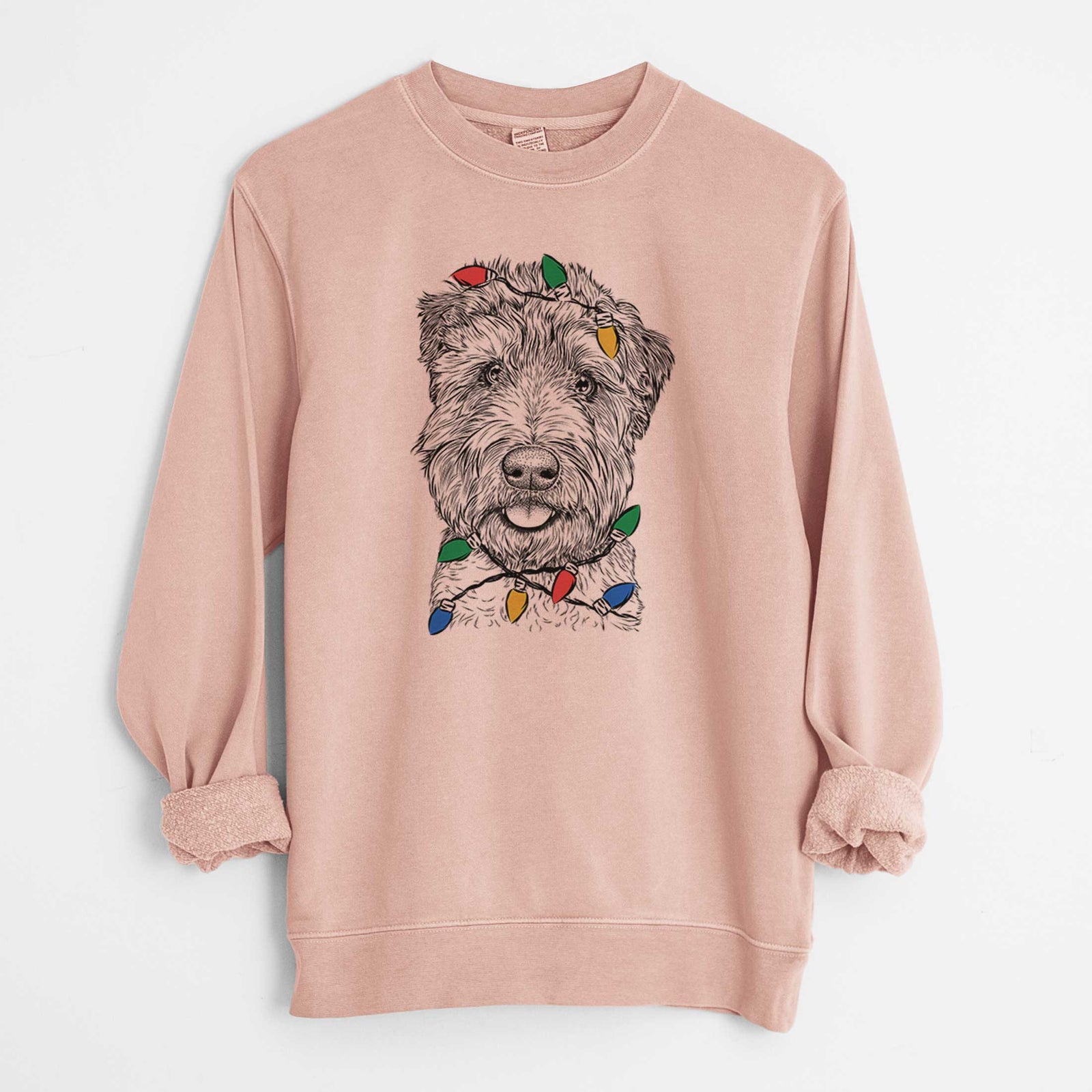 Hand-drawn sketch of Milton the Soft Coated Wheaten Terrier wrapped in Christmas lights on a Dusty Pink Unisex pigment dyed crew sweatshirt