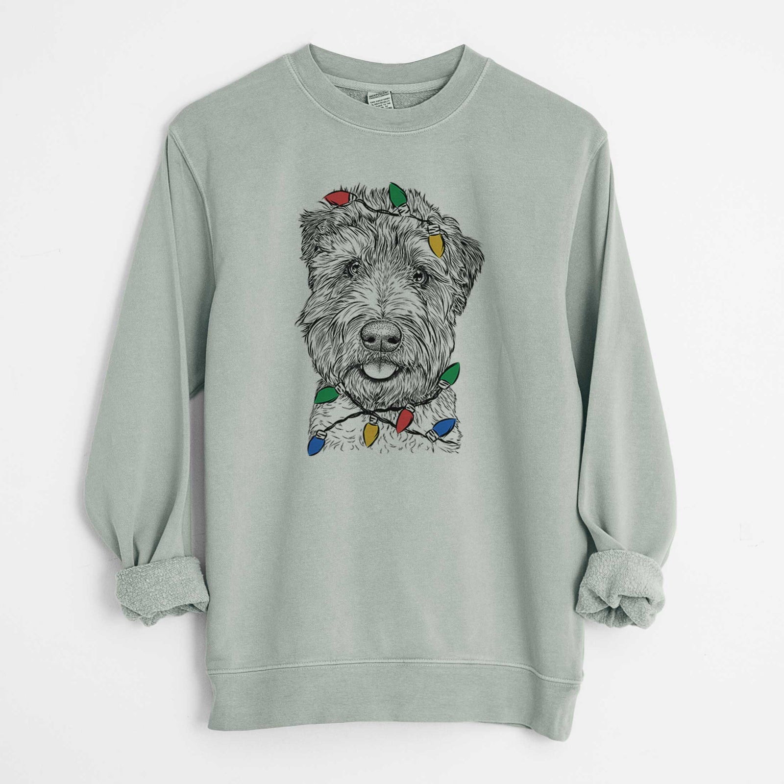 Hand-drawn sketch of Milton the Soft Coated Wheaten Terrier wrapped in Christmas lights on a Sage Unisex pigment dyed crew sweatshirt