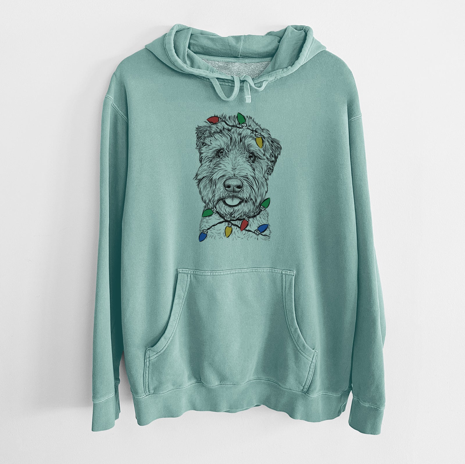 Hand-drawn sketch of Milton the Soft Coated Wheaten Terrier wrapped in Christmas lights on a Mint Unisex pigment dyed hoodie