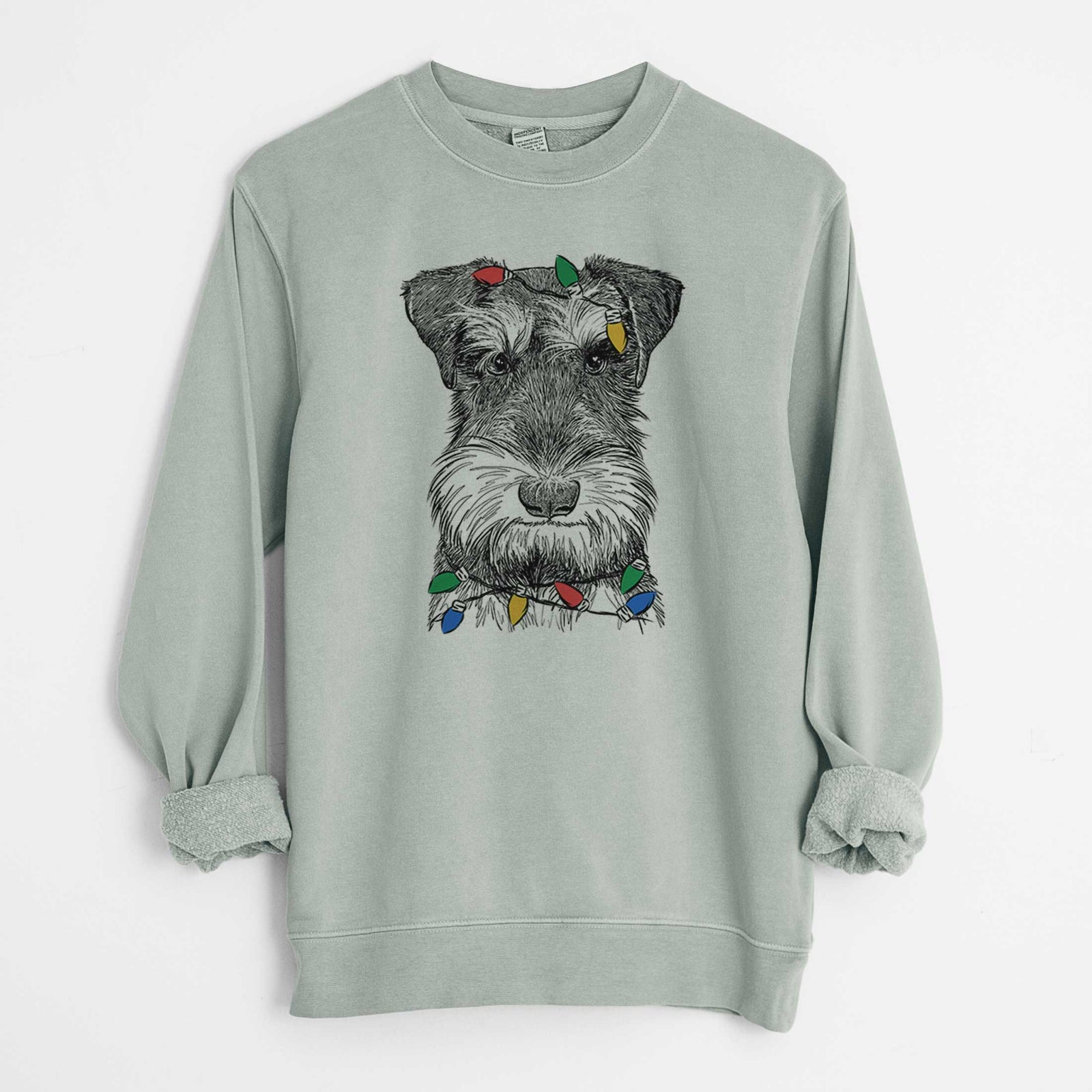 Hand-drawn sketch of Murphy the Mini Schnauzer wrapped in Christmas lights on a Sage Unisex pigment dyed crew sweatshirt