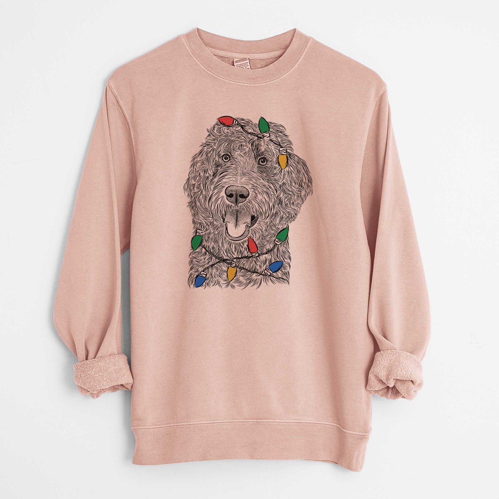 Hand-drawn sketch of Murr Dog the Labradoodle wrapped in Christmas lights on a Dusty Pink Unisex pigment dyed crew sweatshirt
