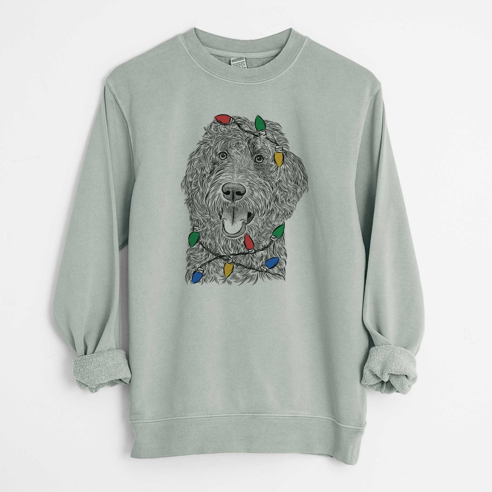 Hand-drawn sketch of Murr Dog the Labradoodle wrapped in Christmas lights on a Sage Unisex pigment dyed crew sweatshirt