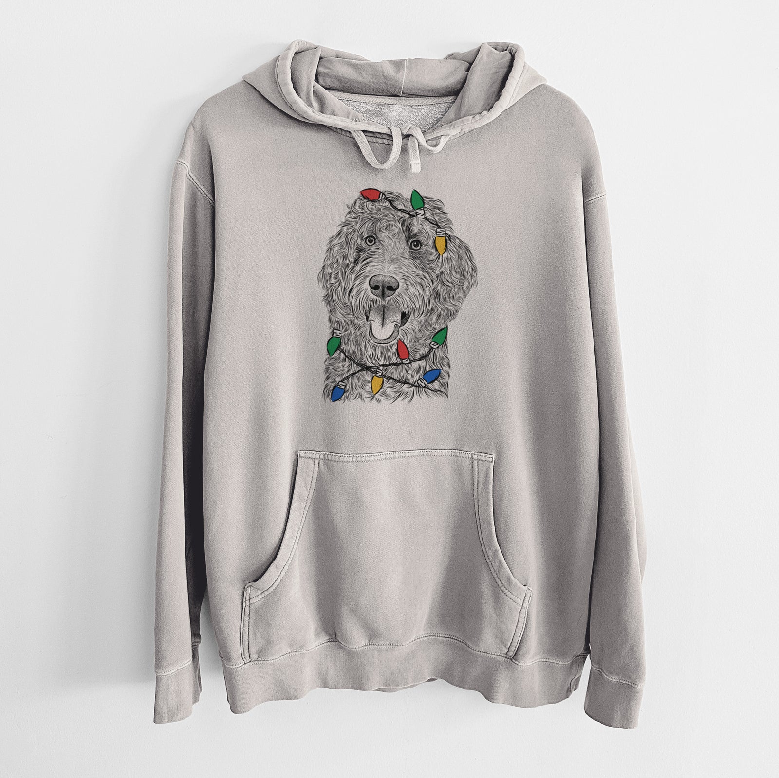 Hand-drawn sketch of Murr Dog the Labradoodle wrapped in Christmas lights on a Cement Unisex pigment dyed hoodie