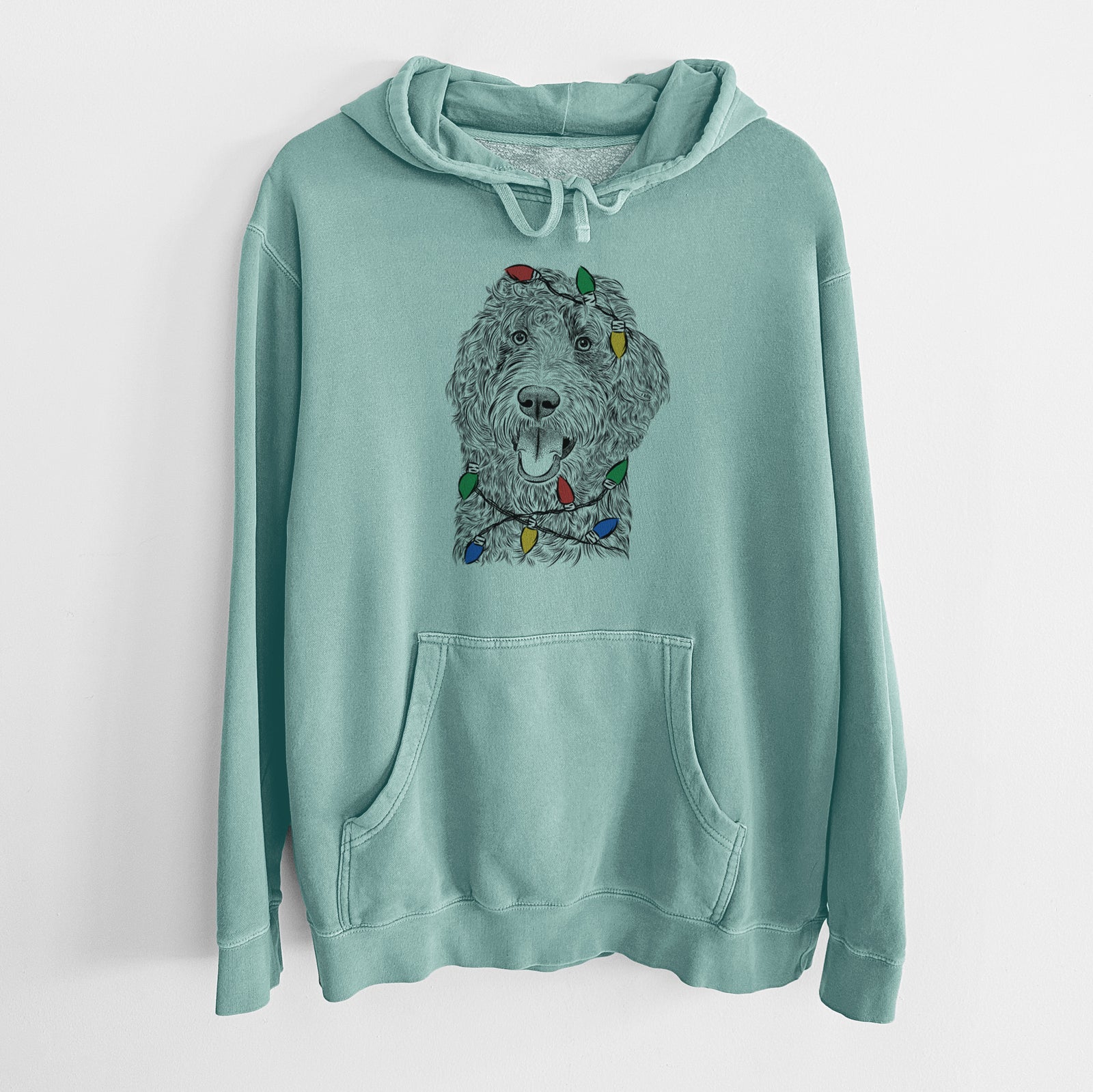 Hand-drawn sketch of Murr Dog the Labradoodle wrapped in Christmas lights on a Mint Unisex pigment dyed hoodie