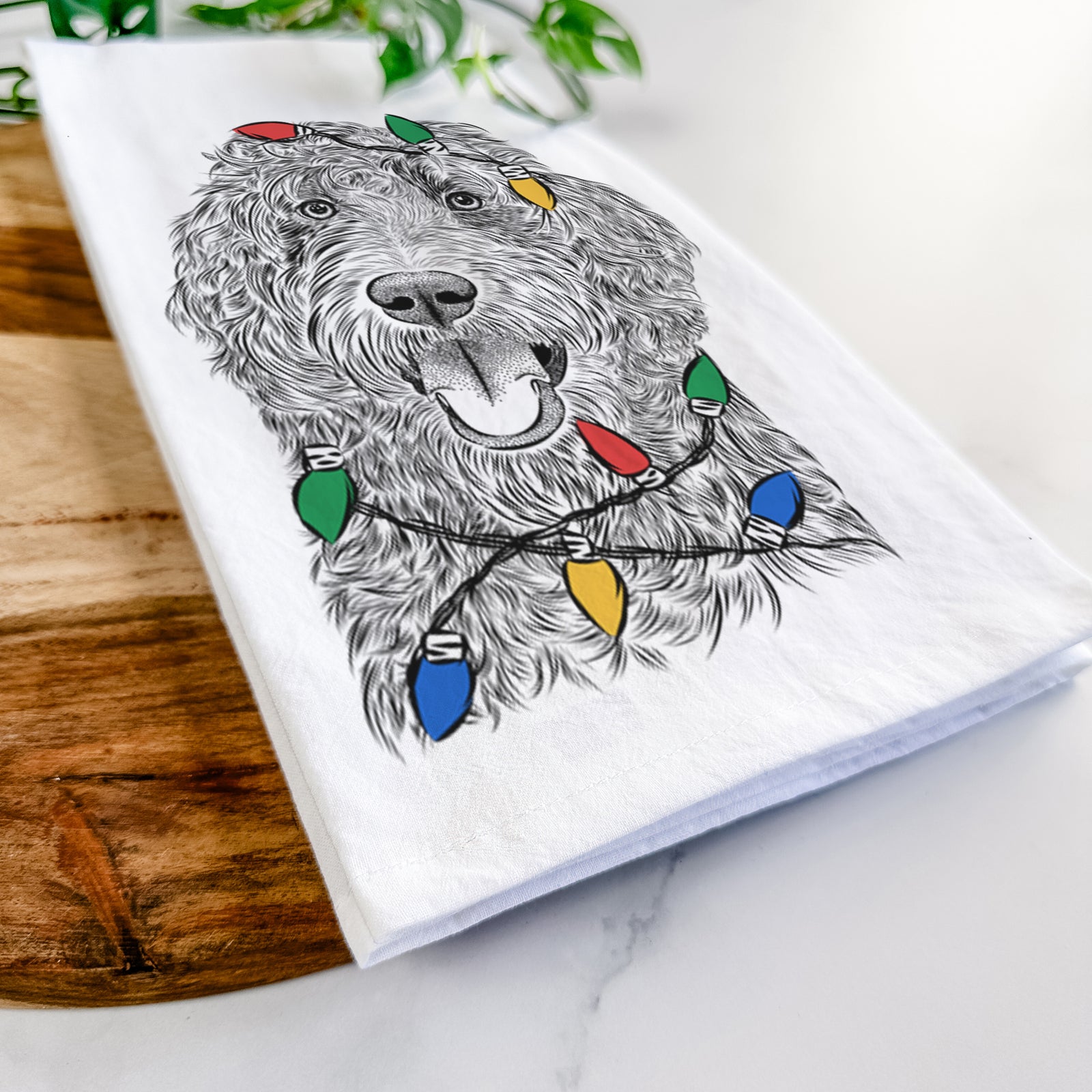 Hand-drawn sketch of Murr Dog the Labradoodle wrapped in Christmas lights on a tea towel