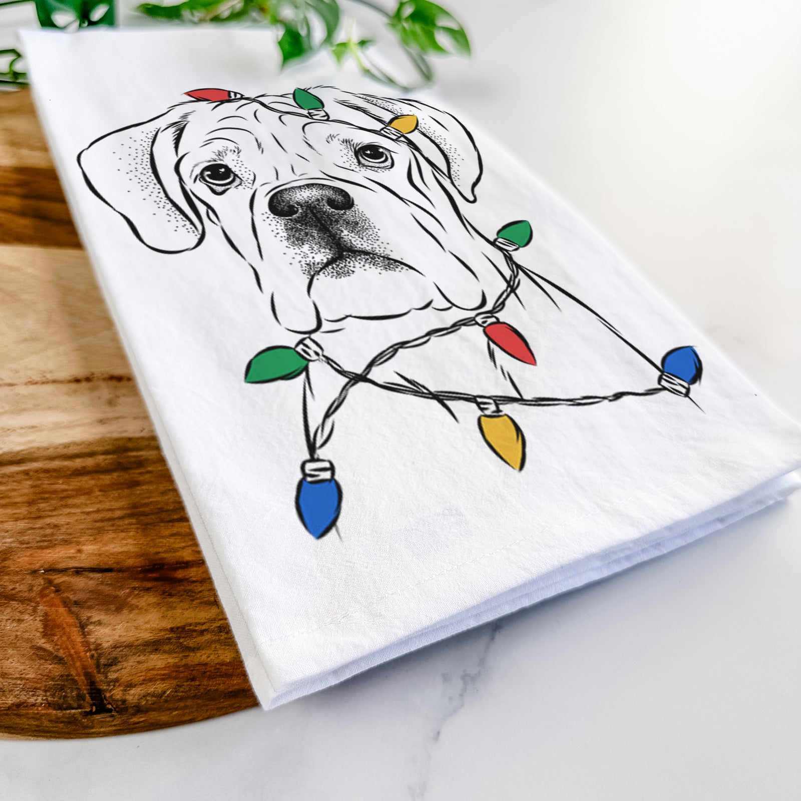 Hand-drawn sketch of Nelly the Boxer wrapped in Christmas lights on a tea towel