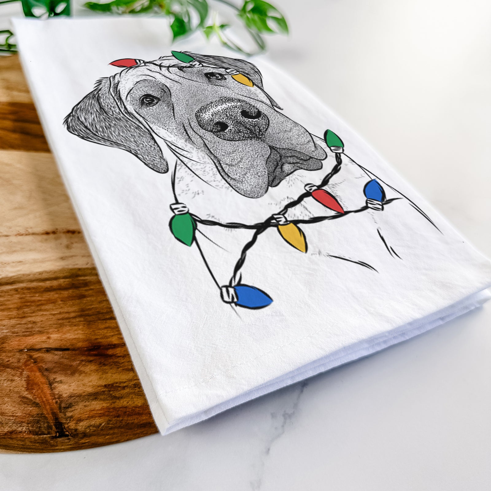 Hand-drawn sketch of Nutterbutter the English Mastiff wrapped in Christmas lights on a tea towel