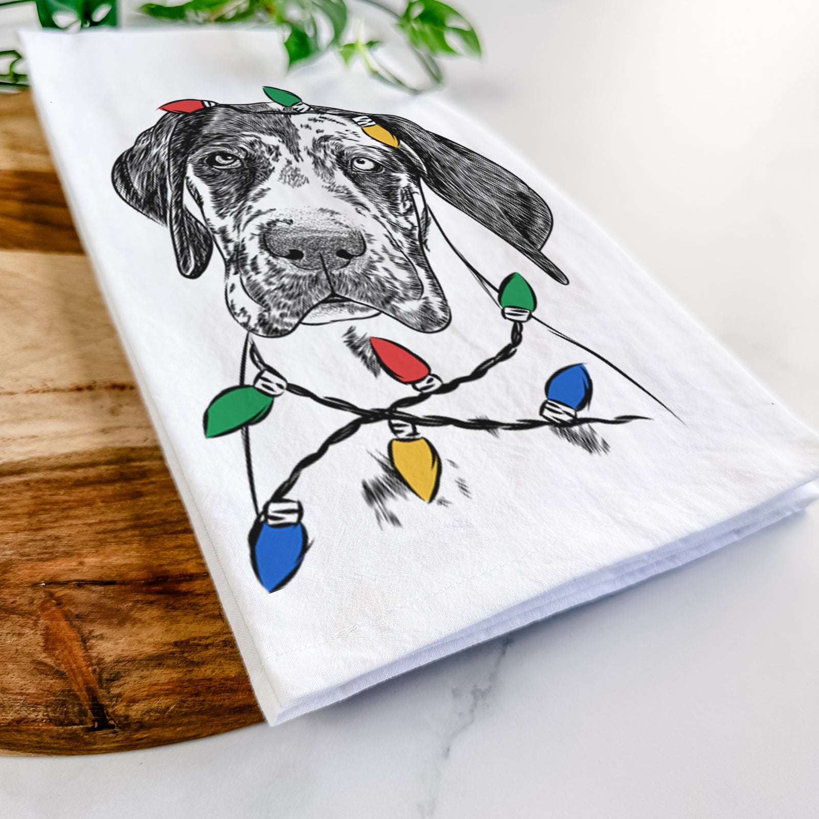 Hand-drawn sketch of Nyx the Great Dane wrapped in Christmas lights on a tea towel