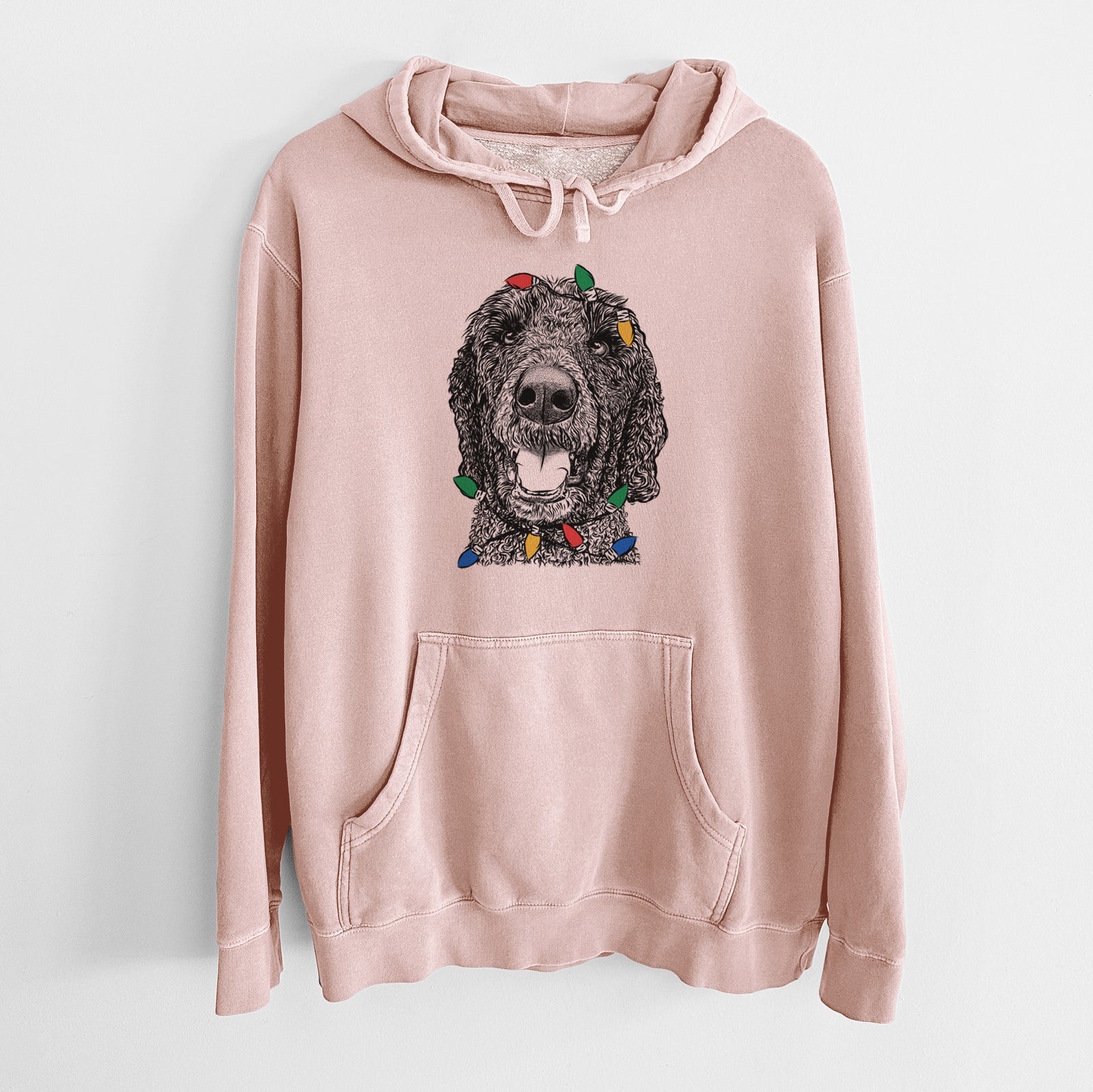 Hand-drawn sketch of Obi James the Goldendoodle wrapped in Christmas lights on a Dusty Pink Unisex pigment dyed hoodie