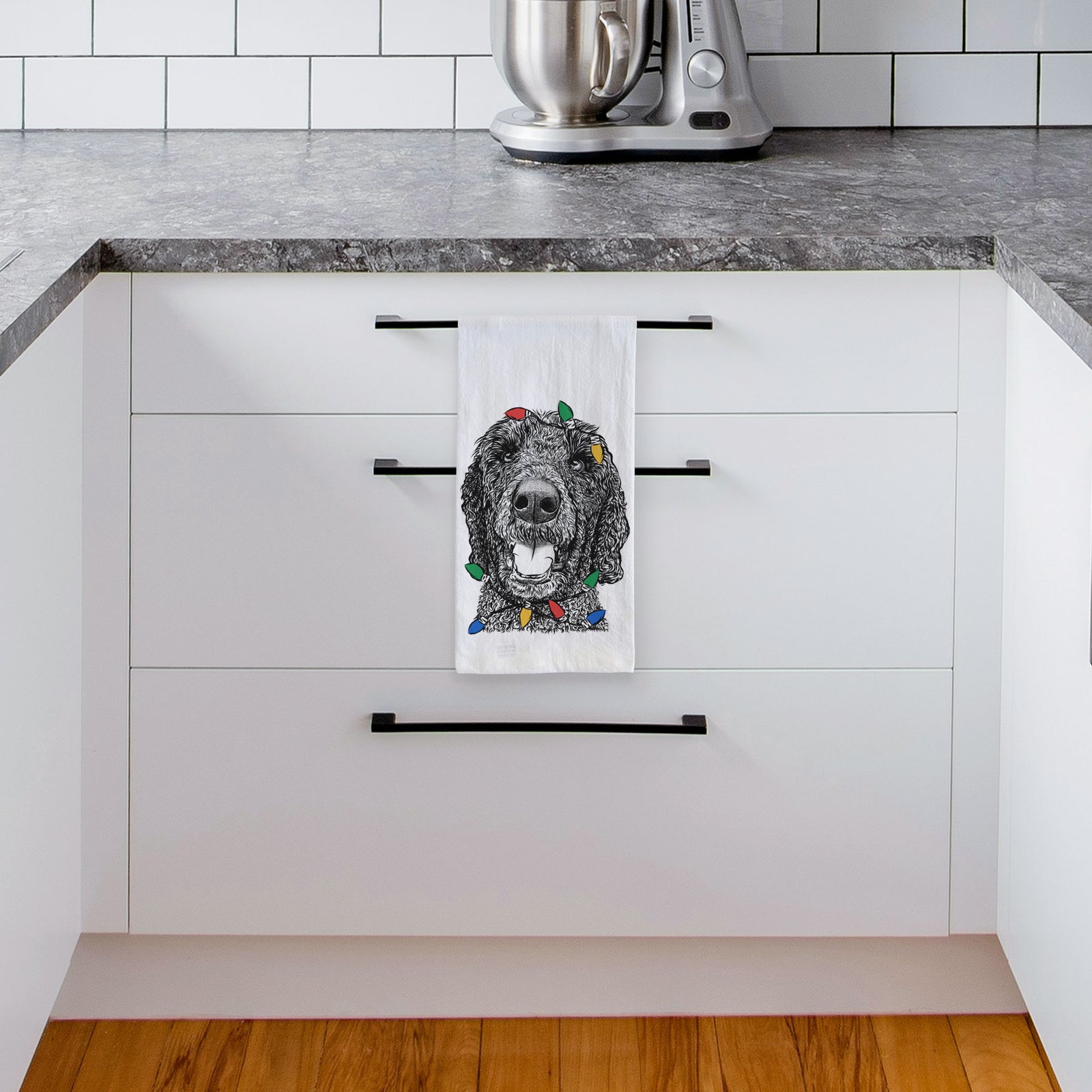 Hand-drawn sketch of Obi James the Goldendoodle wrapped in Christmas lights on a tea towel, hanging on an oven door in a kitchen