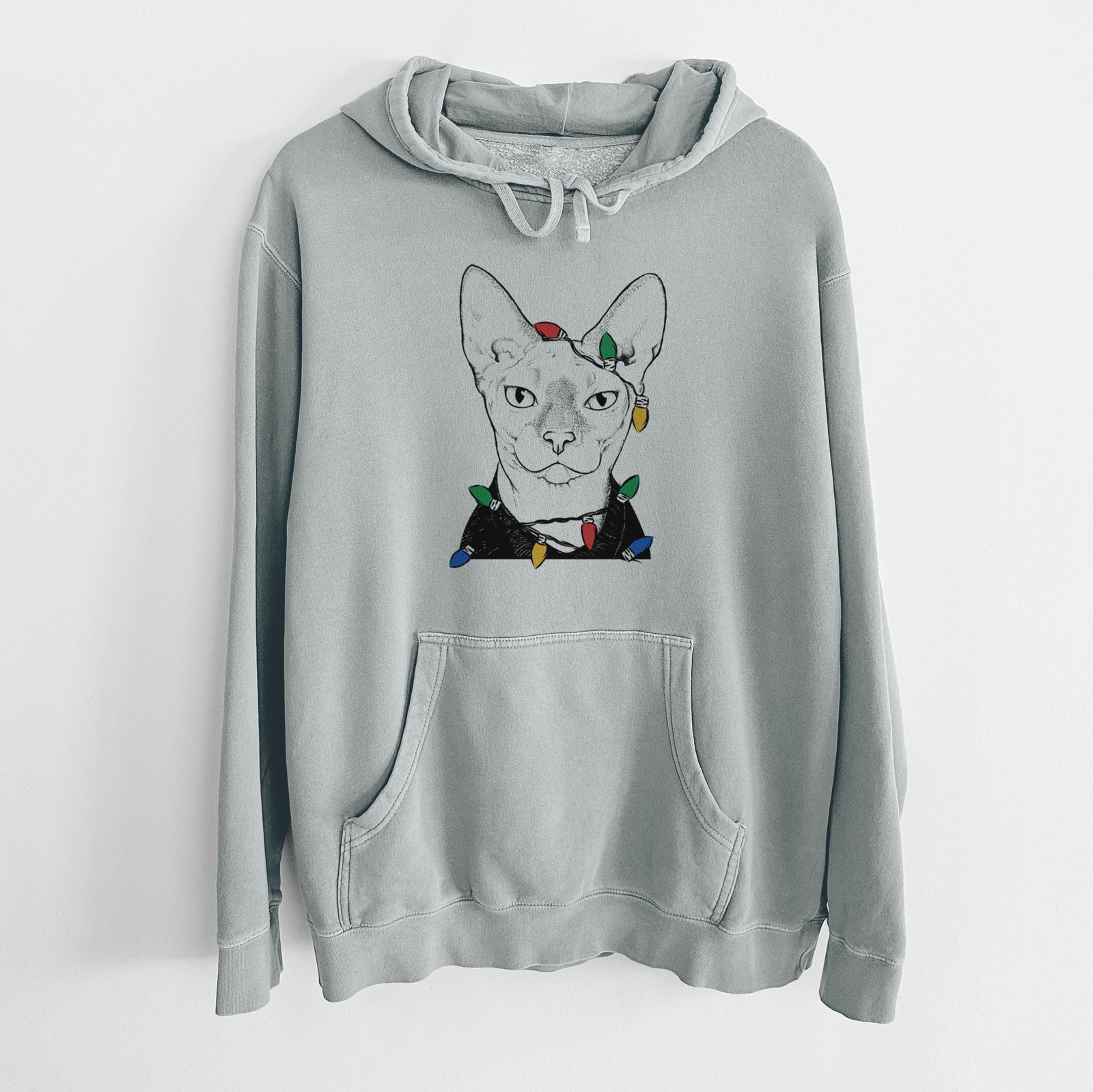 Hand-drawn sketch of Oliver Watson the Sphynx Cat wrapped in Christmas lights on a Sage Unisex pigment dyed hoodie