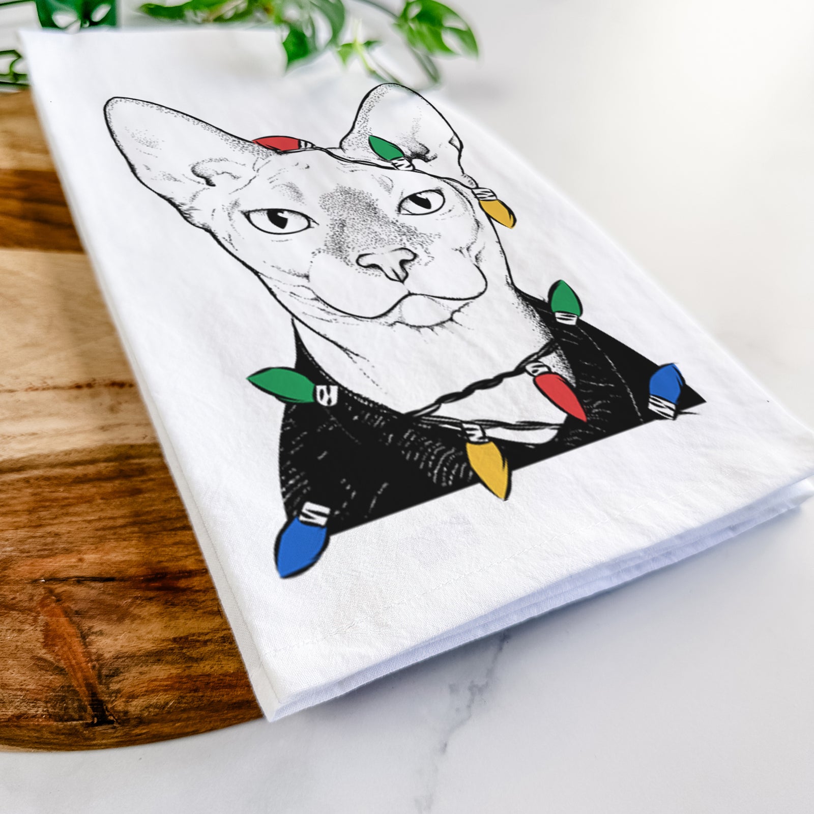 Hand-drawn sketch of Oliver Watson the Sphynx Cat wrapped in Christmas lights on a tea towel