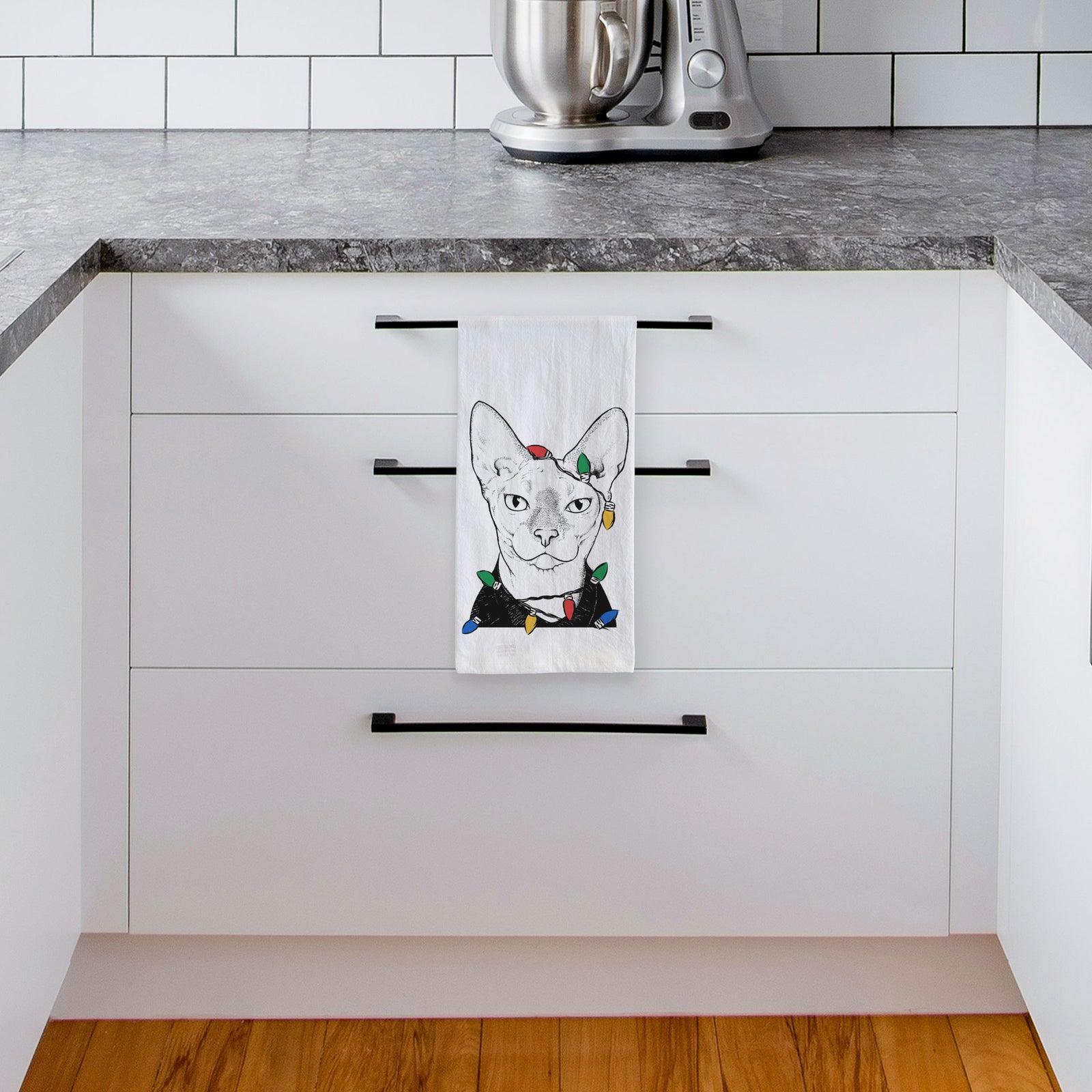 Hand-drawn sketch of Oliver Watson the Sphynx Cat wrapped in Christmas lights on a tea towel, hanging on an oven door in a kitchen