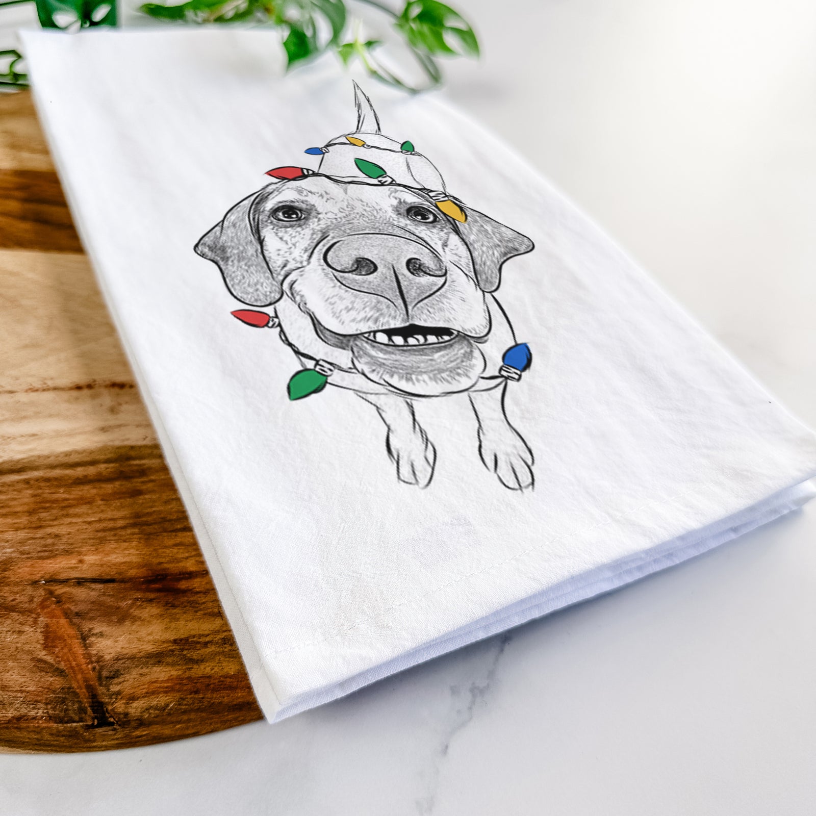 Hand-drawn sketch of Oquirrh the Vizsla wrapped in Christmas lights on a tea towel