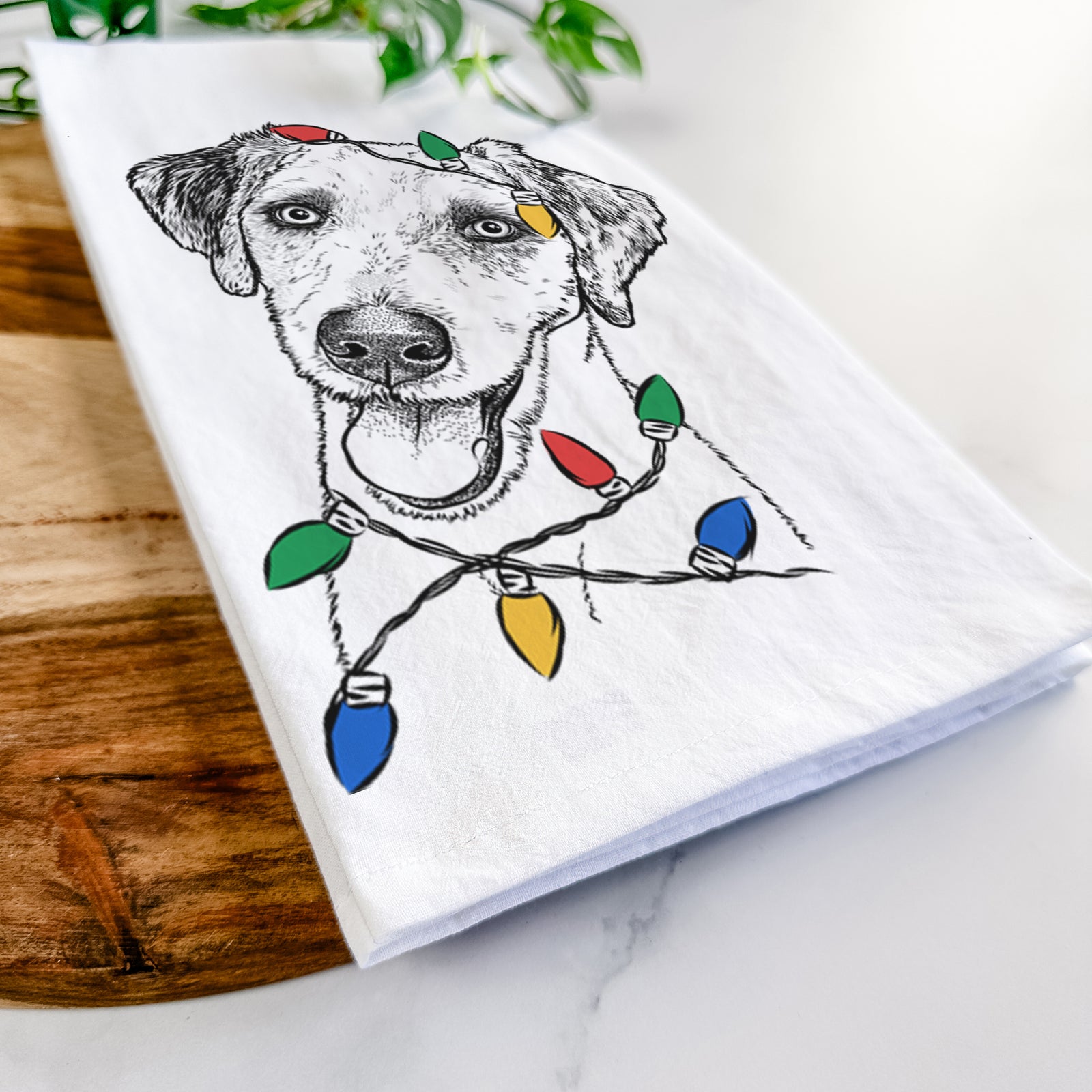 Hand-drawn sketch of Palm Palm the Aussiedoodle wrapped in Christmas lights on a tea towel