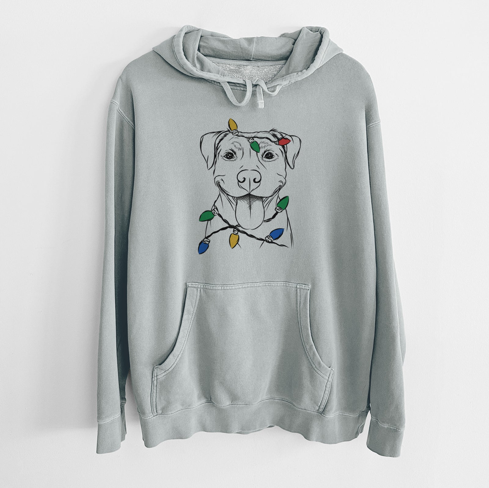 Hand-drawn sketch of Parker the Pitbull wrapped in Christmas lights on a Sage Unisex pigment dyed hoodie