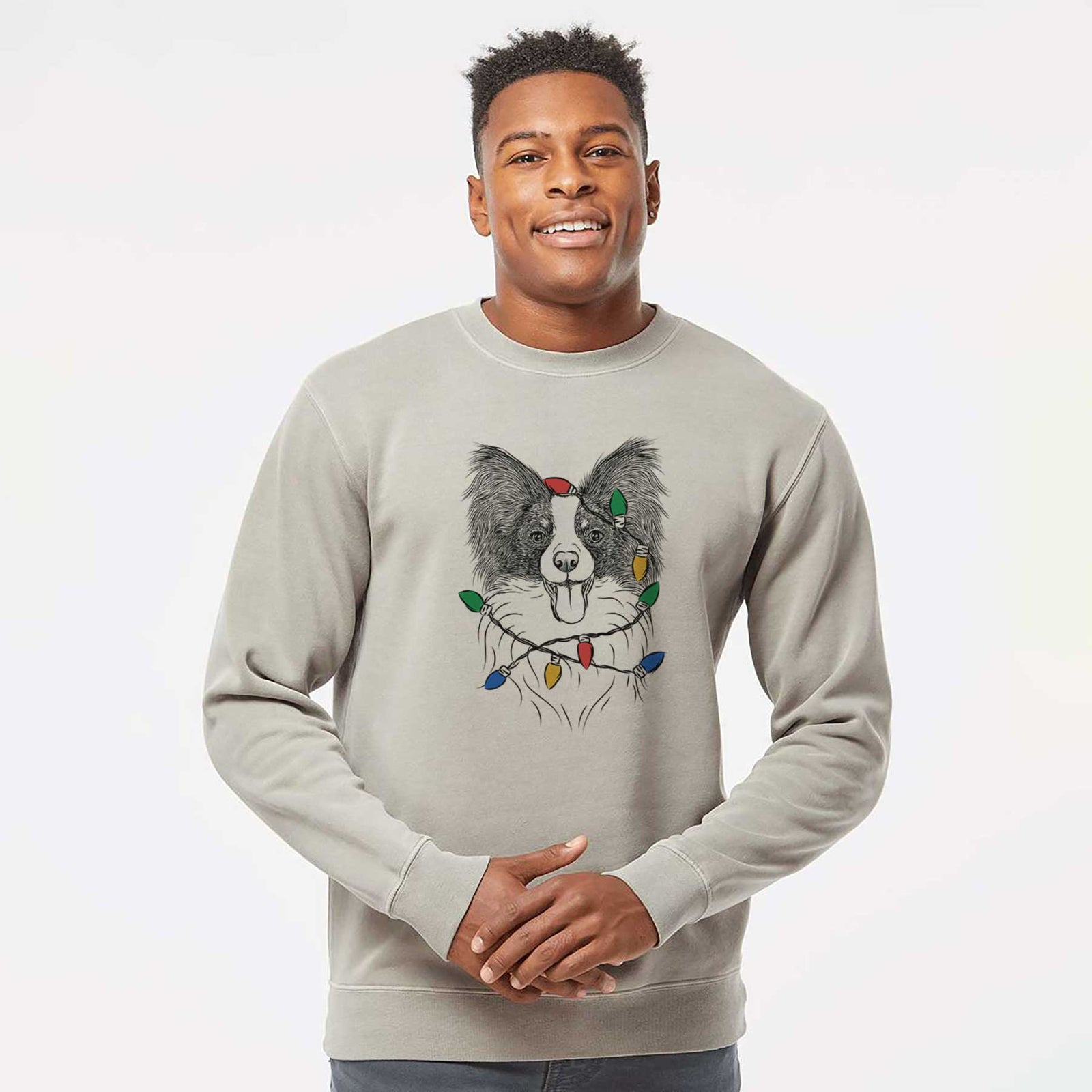 Hand-drawn sketch of Patrick the Papillon wrapped in Christmas lights on a Cement Unisex pigment dyed crew sweatshirt