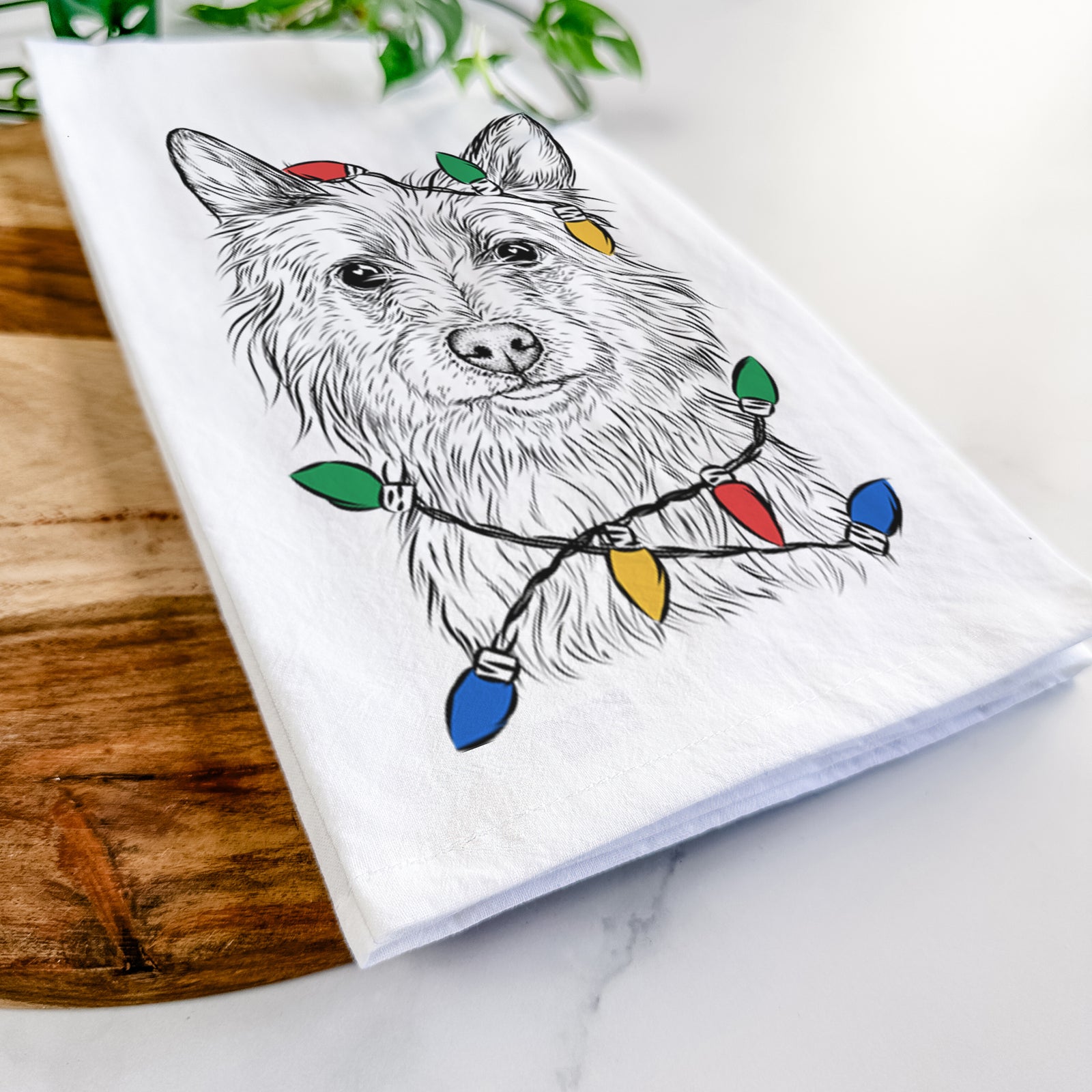 Hand-drawn sketch of Paulo the Portuguese Podengo wrapped in Christmas lights on a tea towel