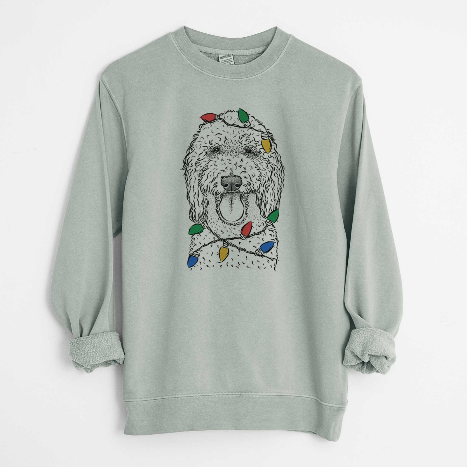 Hand-drawn sketch of Pavlov the Goldendoodle wrapped in Christmas lights on a Sage Unisex pigment dyed crew sweatshirt