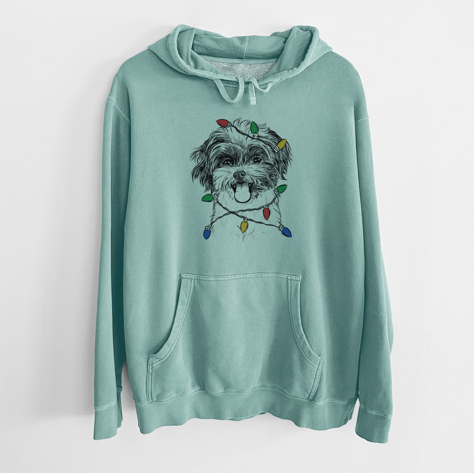 Hand-drawn sketch of Pepper the Shihpoo wrapped in Christmas lights on a Mint Unisex pigment dyed hoodie
