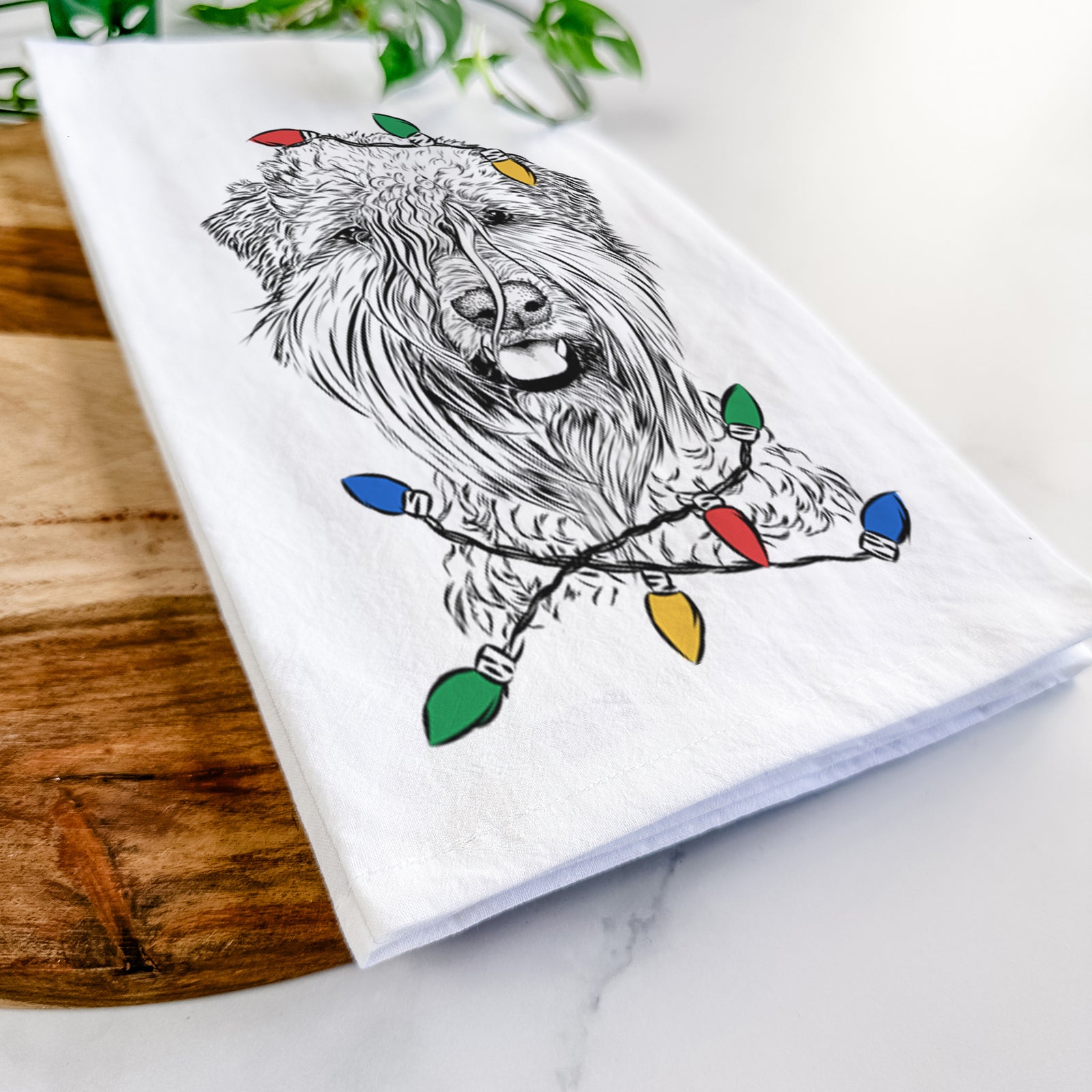 Hand-drawn sketch of Pierre the Soft Coated Wheaten Terrier wrapped in Christmas lights on a tea towel