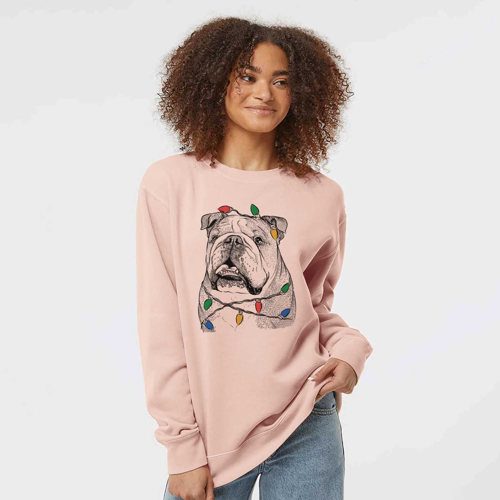 Hand-drawn sketch of Piggy the English Bulldog wrapped in Christmas lights on a Dusty Pink Unisex pigment dyed crew sweatshirt