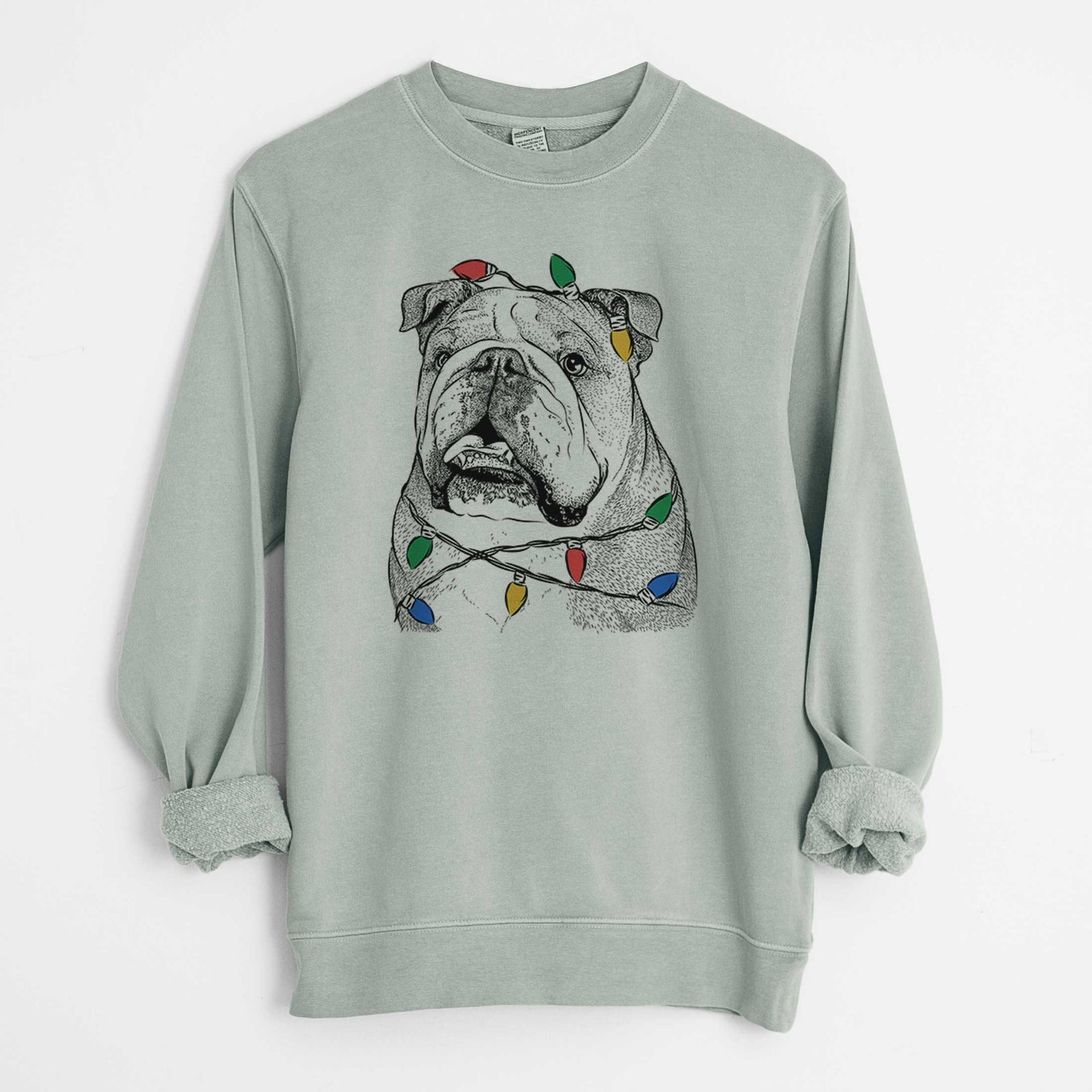 Hand-drawn sketch of Piggy the English Bulldog wrapped in Christmas lights on a Sage Unisex pigment dyed crew sweatshirt