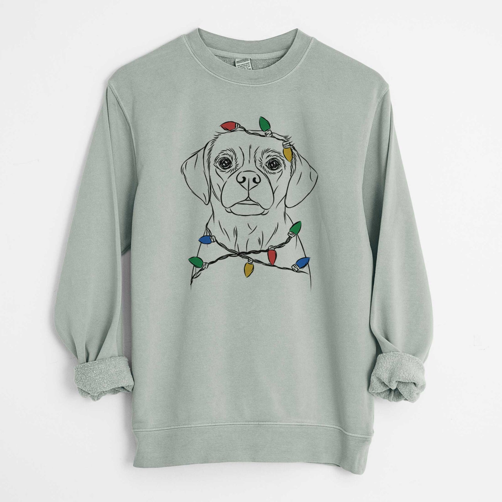 Hand-drawn sketch of Popcorn the Puggle wrapped in Christmas lights on a Sage Unisex pigment dyed crew sweatshirt