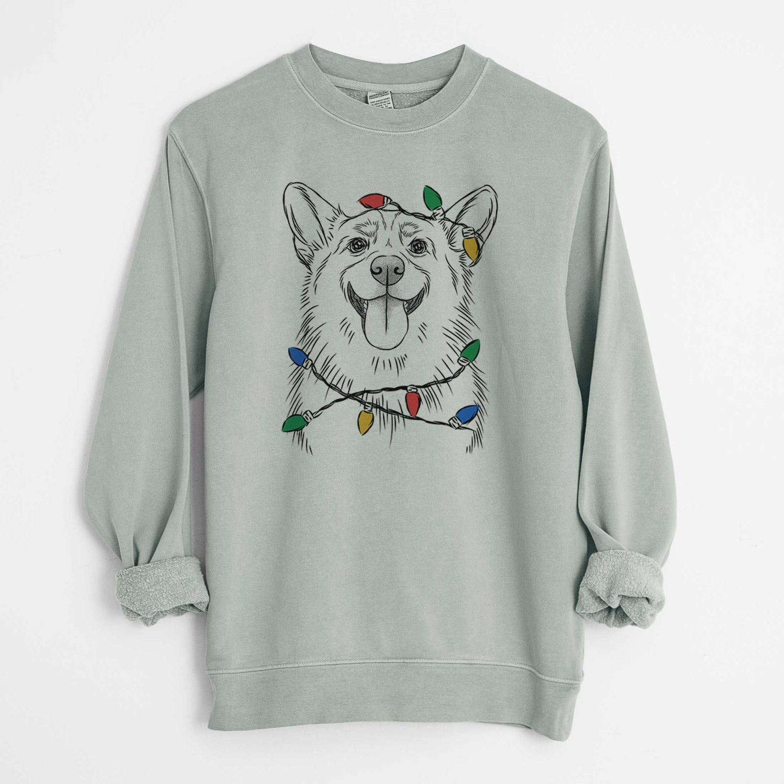 Hand-drawn sketch of Porter the Pembroke Welsh Corgi wrapped in Christmas lights on a Sage Unisex pigment dyed crew sweatshirt