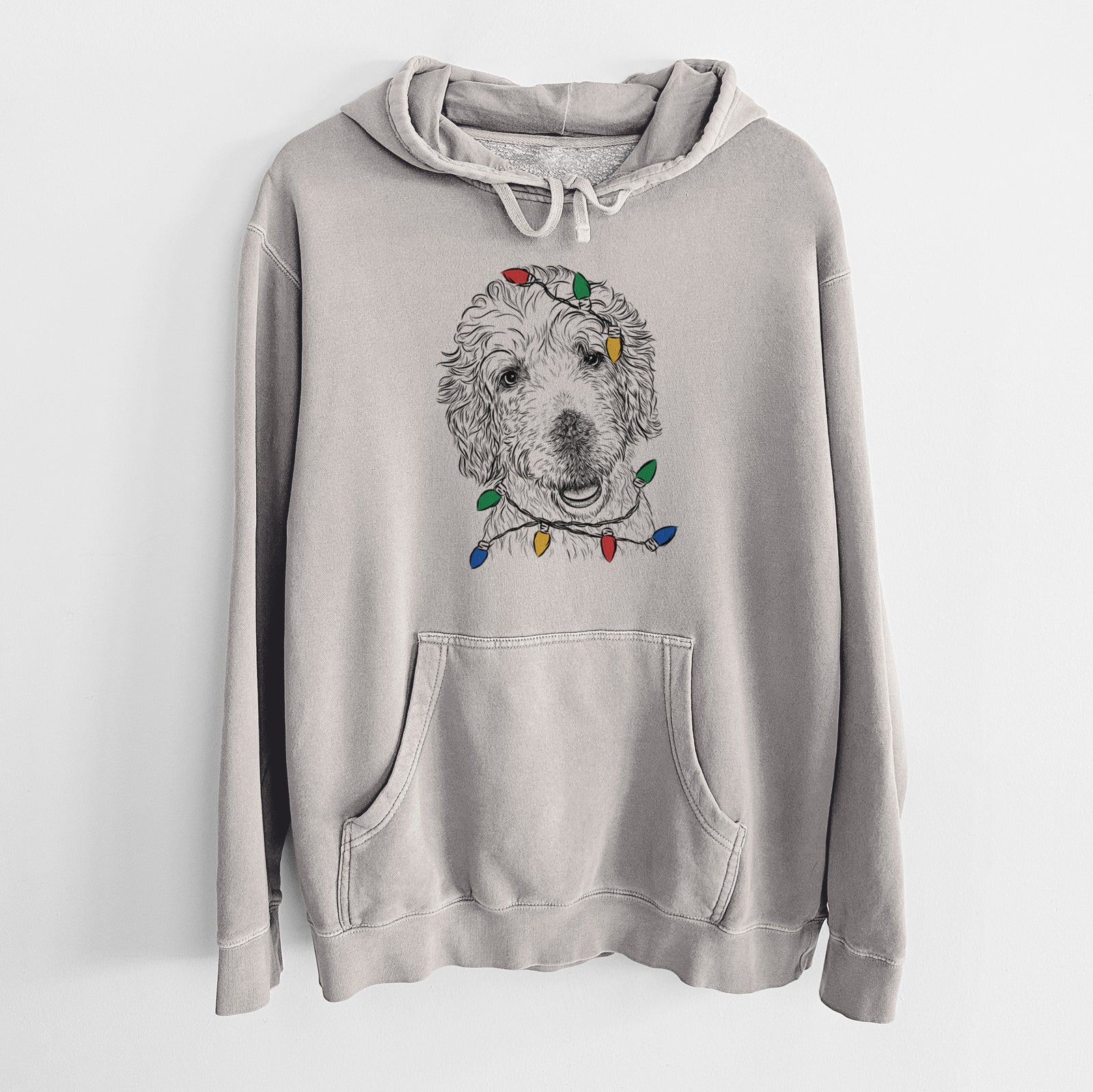 Hand-drawn sketch of Preston the Labradoodle wrapped in Christmas lights on a Cement Unisex pigment dyed hoodie