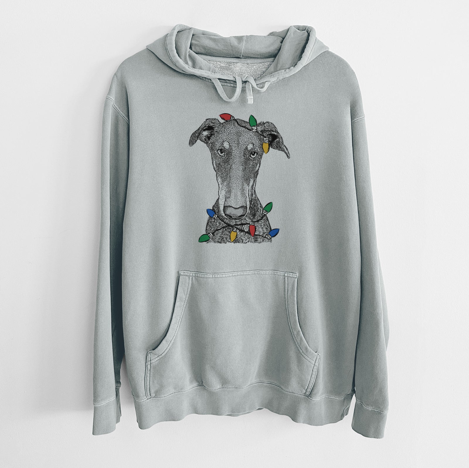 Hand-drawn sketch of Princess Fiona the Doberman Pinscher wrapped in Christmas lights on a Sage Unisex pigment dyed hoodie