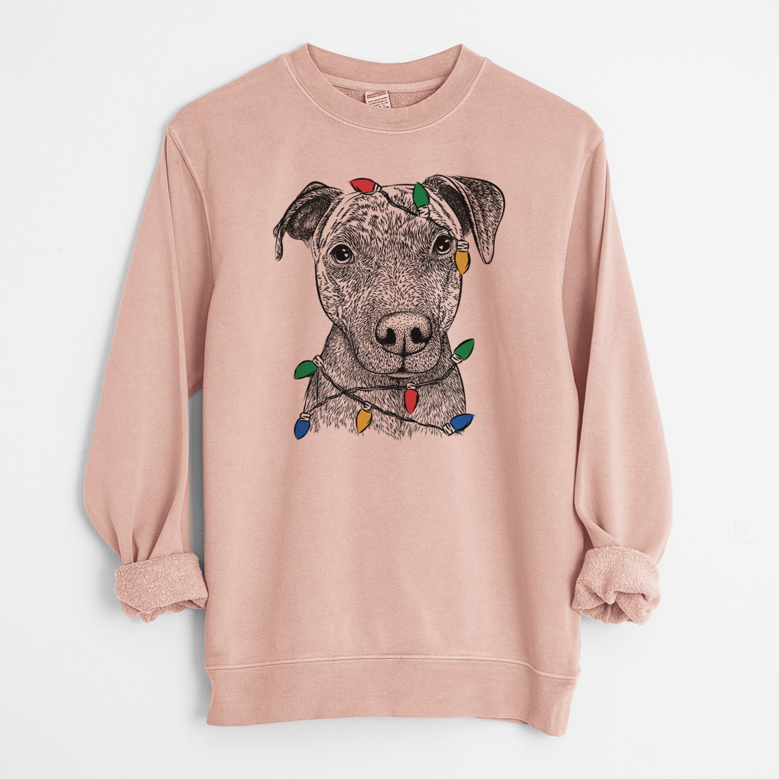 Hand-drawn sketch of Reeses the Pitbull wrapped in Christmas lights on a Dusty Pink Unisex pigment dyed crew sweatshirt