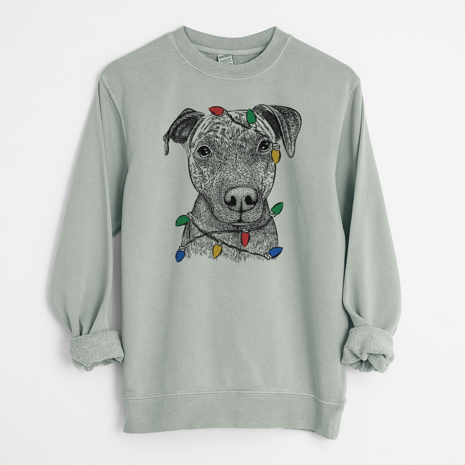Hand-drawn sketch of Reeses the Pitbull wrapped in Christmas lights on a Sage Unisex pigment dyed crew sweatshirt