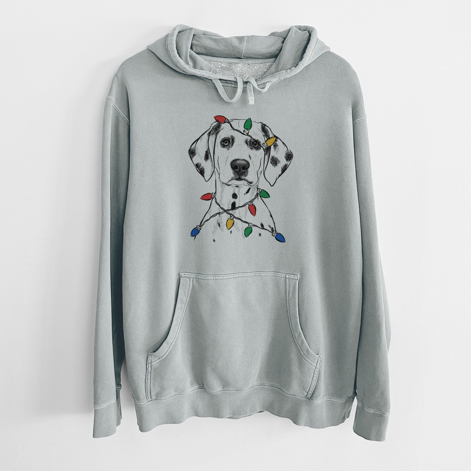 Hand-drawn sketch of Riot the Dalmatian wrapped in Christmas lights on a Sage Unisex pigment dyed hoodie