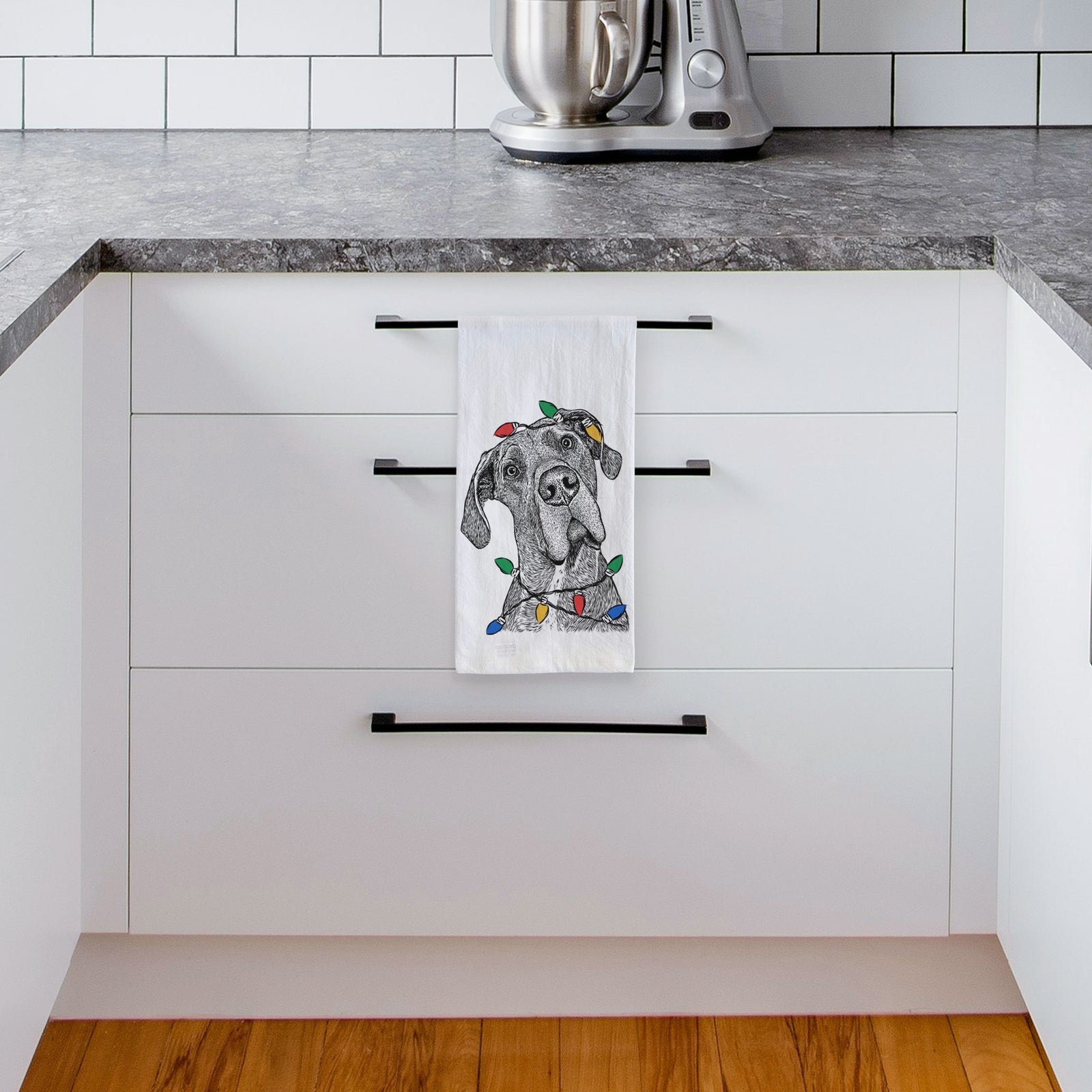 Hand-drawn sketch of River the Great Dane wrapped in Christmas lights on a tea towel, hanging on an oven door in a kitchen